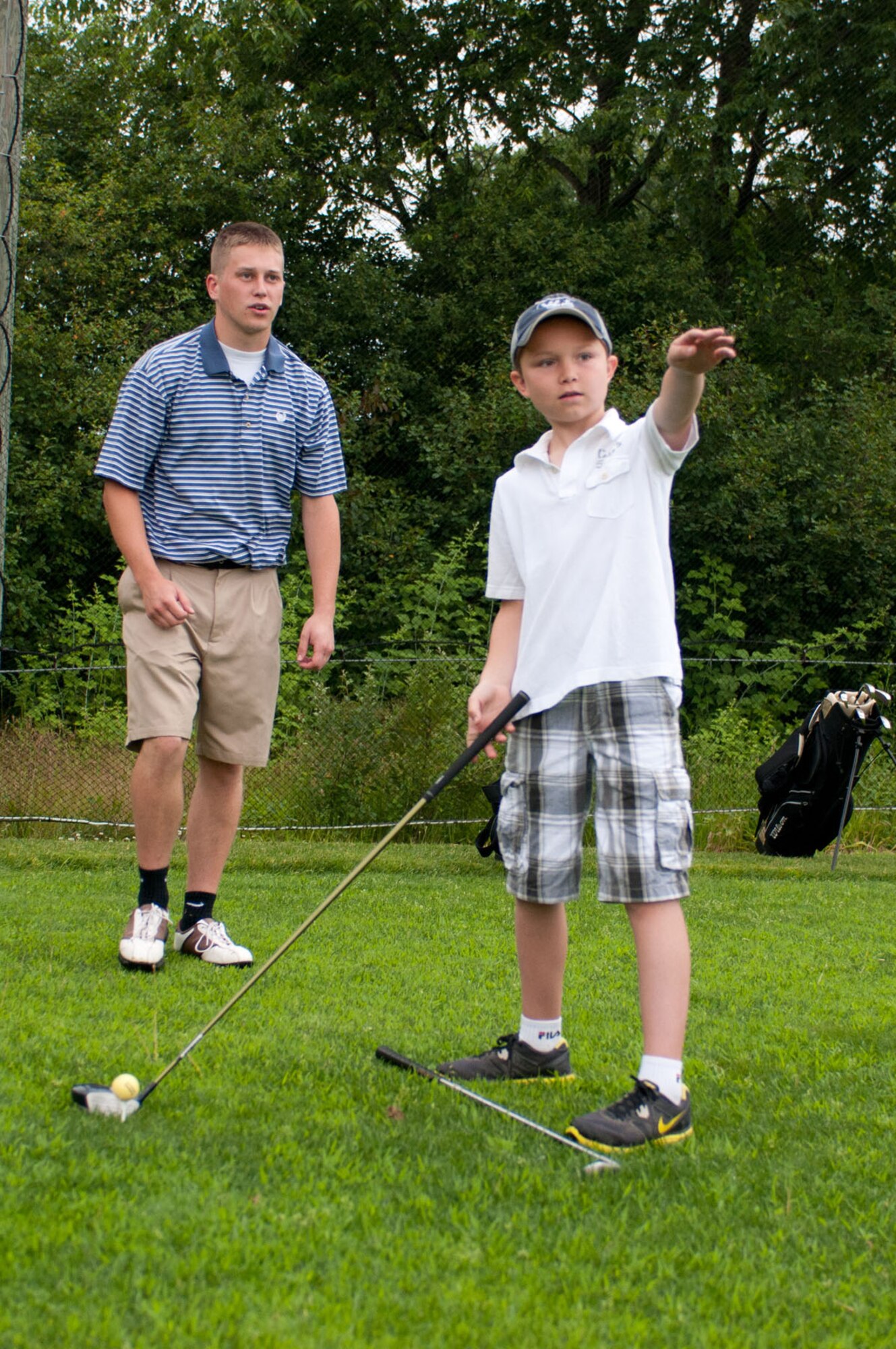 BEDFORD, Mass. - Davis Richard receives alignment instruction from Tyler Cummings during the first Golf 4 Kids session at the Patriot Golf Course June 25. Another session is available Aug. 6 through 9 that teaches children about swing mechanics, etiquette, terminology and more. (U.S. Air Force photo by Rick Berry)