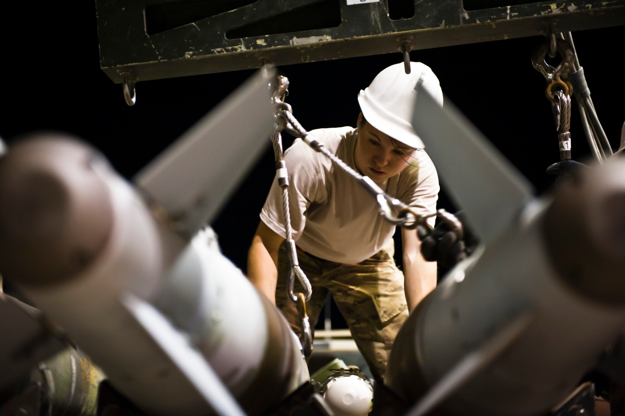 TSgt Jessica Evans, Munitions Systems Specialist with the 455th Maintenance Squadron, loads GBU-38 smart bombs onto a trailer at Bagram Airfield, Afghanistan, June 29, 2012. 455 MXS Munitions Airmen work 24/7 to provide the ammo used by Bagram aircraft to defeat insurgents and protect friendly forces in Afghanistan. (U.S. Air Force photo/Capt. Raymond Geoffroy)