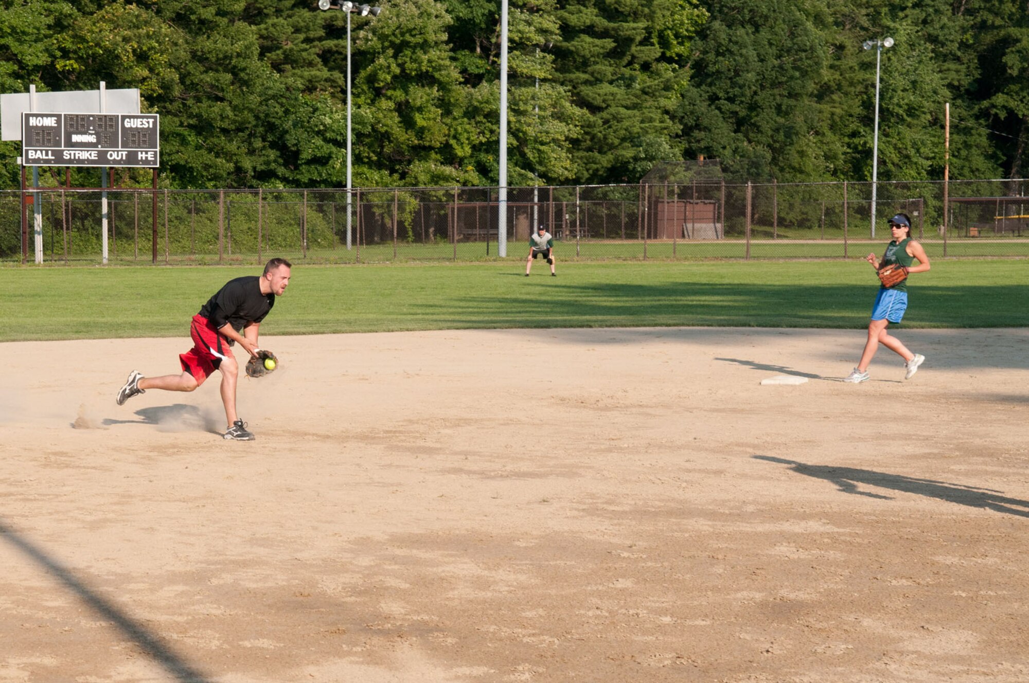 HANSCOM AIR FORCE BASE, Mass. – Jordan Wagner, a member of the ESC/HSIB recreational softball team, fields the ball during a game against PK June 21. In addition to recreational softball, intramural softball and intramural golf are being played this summer. (U.S. Air Force photo by Rick Berry)