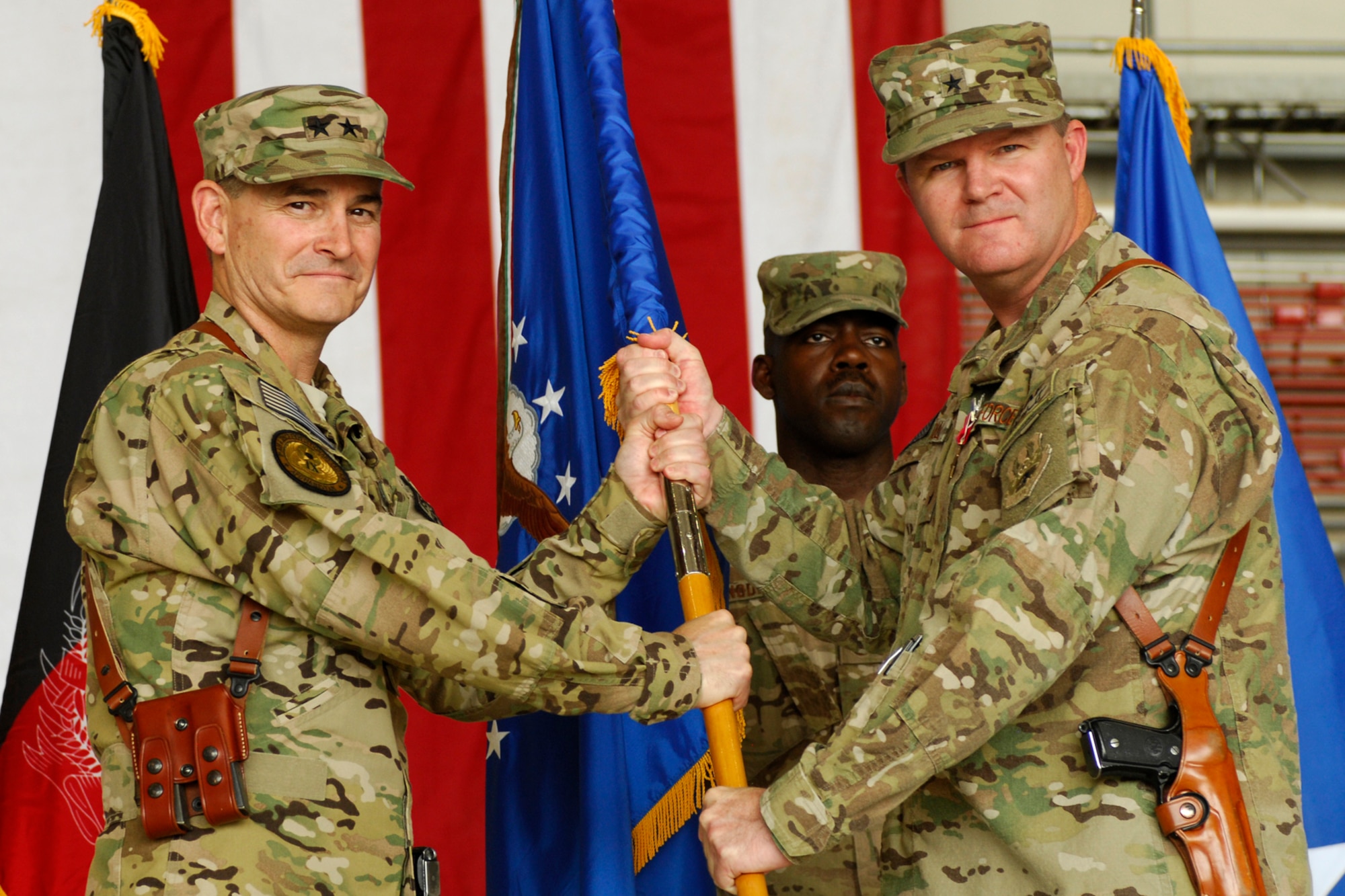 Maj. Gen. H. D. Polumbo, 9th Air and Space Expeditionary Task Force-Afghanistan commander, receives the 455th Air Expeditionary Wing guidon from Brig. Gen. Thomas Deale as he relinquishes command of the 455 AEW at Bagram Airfield, Afghanistan, July 12, 2012. Deale turned over command of the wing to Brig. Gen. Joseph Guastella. (U.S. Air Force photo/SSgt. Jeff Nevison)