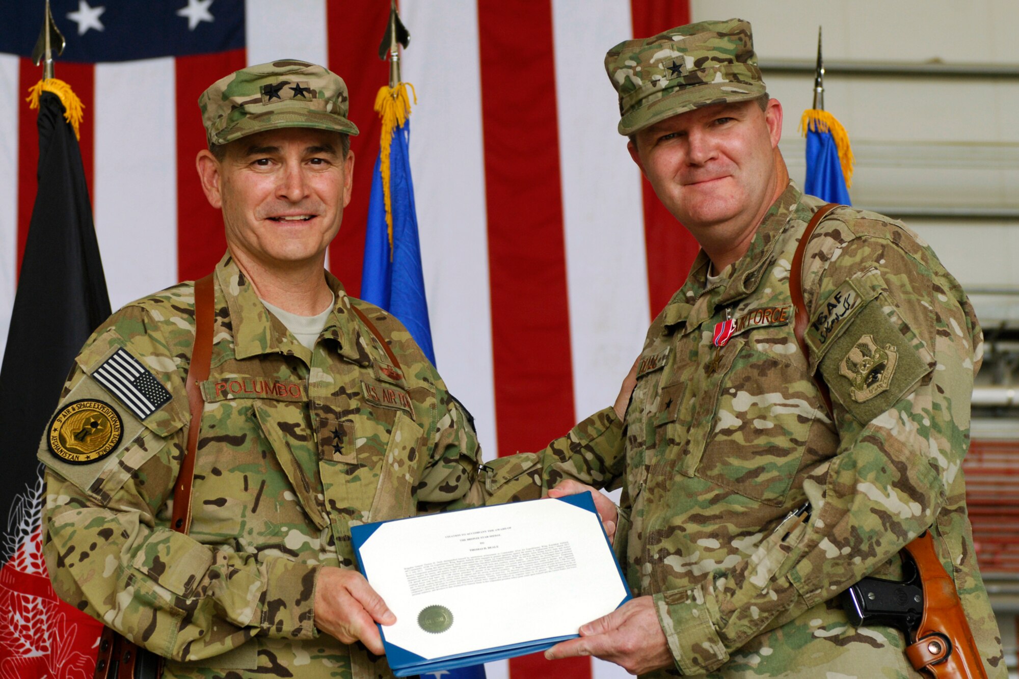 Maj. Gen. H. D. Polumbo, 9th Air and Space Expeditionary Task Force-Afghanistan commander, presents a Bronze Star certificate to Brig. Gen. Thomas Deale before Deale relinquishes command of the 455th Air Expeditionary Wing at Bagram Airfield, Afghanistan, July 12, 2012. (U.S. Air Force photo/SSgt. Jeff Nevison)
