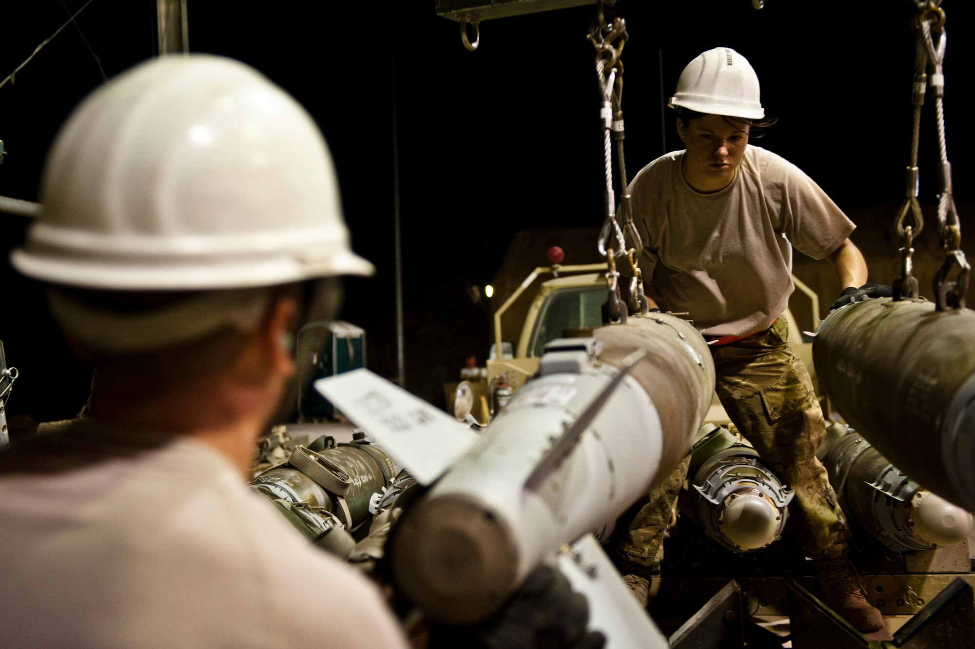 TSgt Jessica Evans, Munitions Systems Specialist with the 455th Maintenance Squadron, loads GBU-38 smart bombs onto a trailer at Bagram Airfield, Afghanistan, June 29, 2012. Evans and her fellow maintainers sustain the fight by providing reliable, precise firepower to BAF’s aircrews. (U.S. Air Force photo/Capt. Raymond Geoffroy)