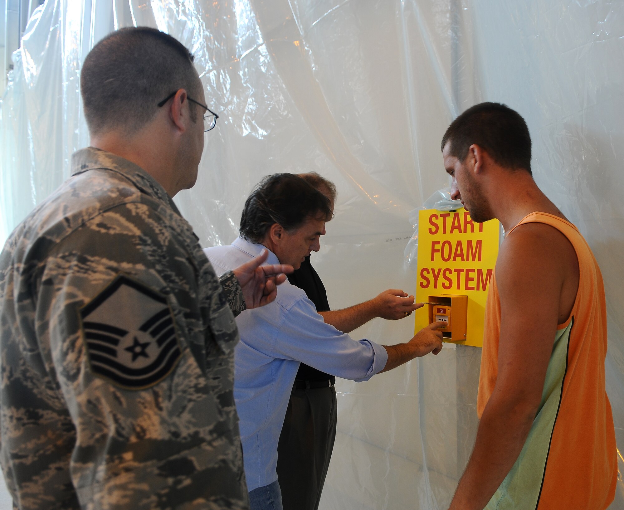 Master Sgt. Tommy Behrman, 31st Maintenance Group loading standardization crew chief, goes over the process of how to start the newly-completed fire suppressant system in Hangar 3 July 11 at Aviano Air Base, Italy. In case of a fire, heat sensors activate an alarm and flashing lights, giving personnel working in the hangar 20 seconds to evacuate before the foam is released. In case heat sensors are faulty, there are manual activation systems located throughout the hangar. (U.S. Air Force photo/Senior Airman Katherine Windish)
 
