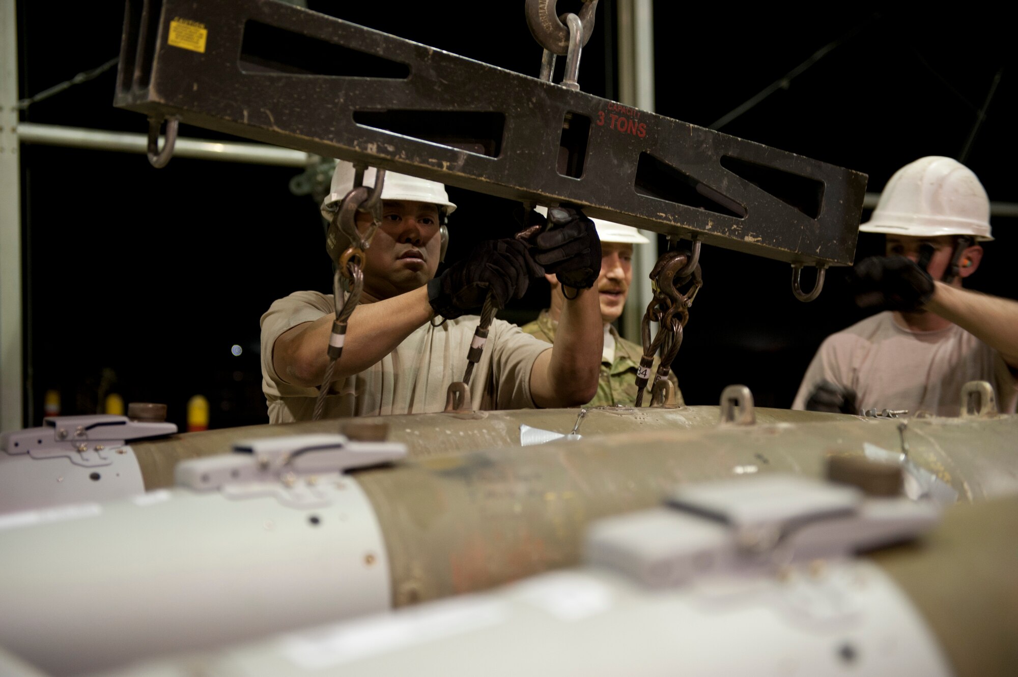 SSgt Dennis Arias, Munitions Systems Specialist with the 455th Maintenance Squadron, loads GBU-38 smart bombs onto a trailer at Bagram Airfield, Afghanistan, June 29, 2012. 455 MXS Munitions Airmen work 24/7 to provide the ammo used by Bagram aircraft to defeat insurgents and protect friendly forces in Afghanistan. (U.S. Air Force photo/Capt. Raymond Geoffroy)