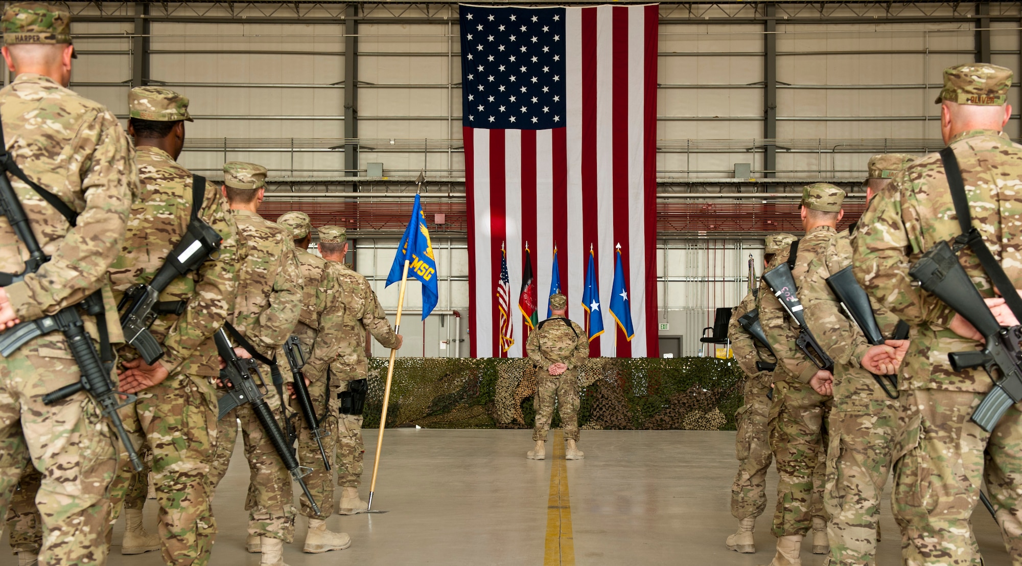 Airmen from the 455th Air Expeditionary Wing stand in formation awaiting the 455 AEW change of command ceremony at Bagram Airfield, Afghanistan, July 12, 2012. Maj. Gen. H. D. Polumbo, 9th Air Expeditionary Task Force-Afghanistan commander, presided over the ceremony in which Brig. Gen. Thomas Deale relinquished command and Brig. Gen. Joseph Guastella assumed command. (U.S. Air Force Photo/Capt. Raymond Geoffroy)