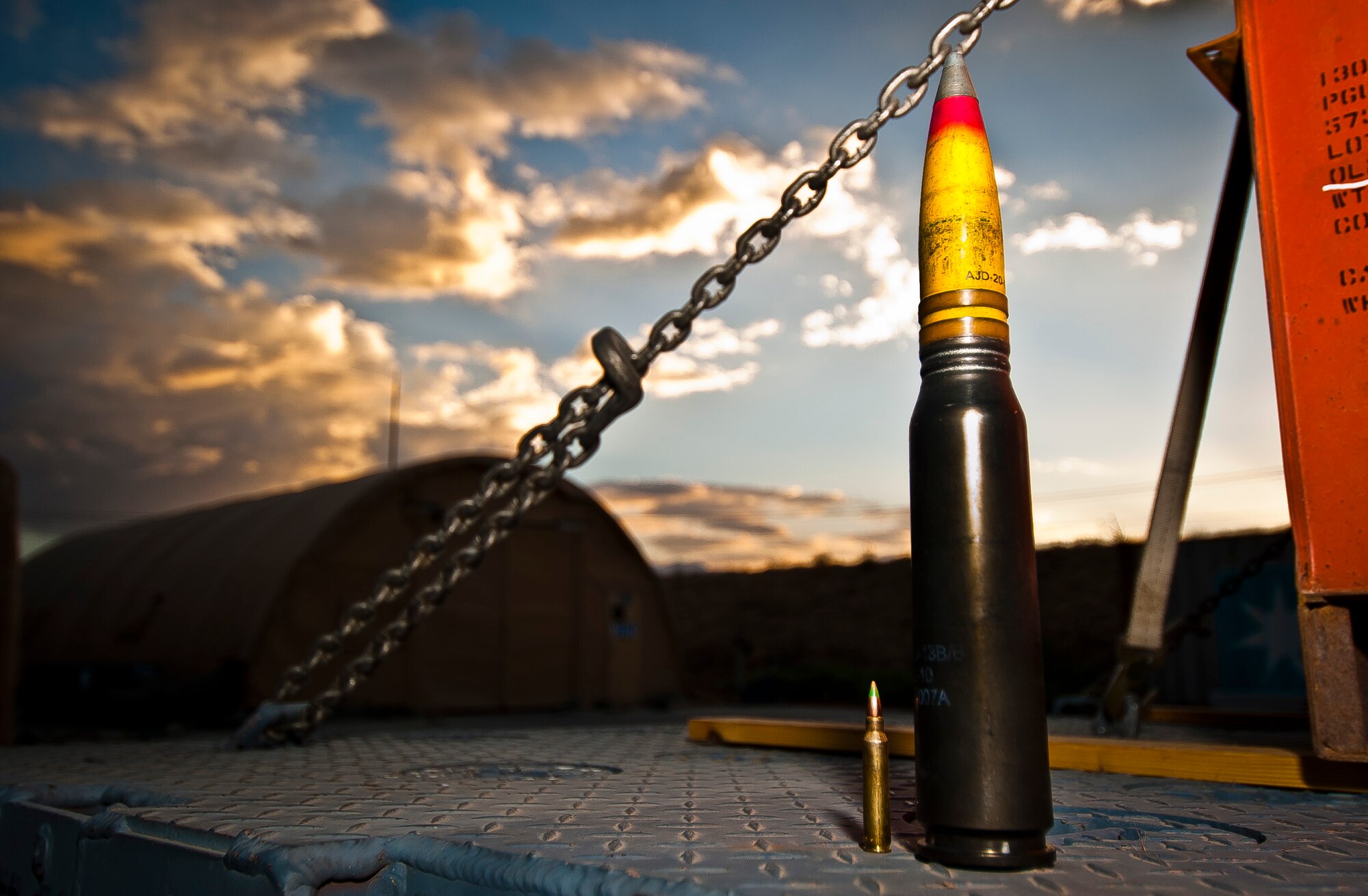A 30mm High Explosive Incendiary round for the U.S. Air Force A-10 Thunderbolt II’s GAU-8/A ‘Avenger’ cannon stands next to a NATO 5.56mm round at Bagram Airfield, Afghanistan, June 23, 2012. 455 MXS Munitions Airmen are responsible for processing and inspecting the A-10’s specialized ammunition. (U.S. Air Force photo/Capt. Raymond Geoffroy)