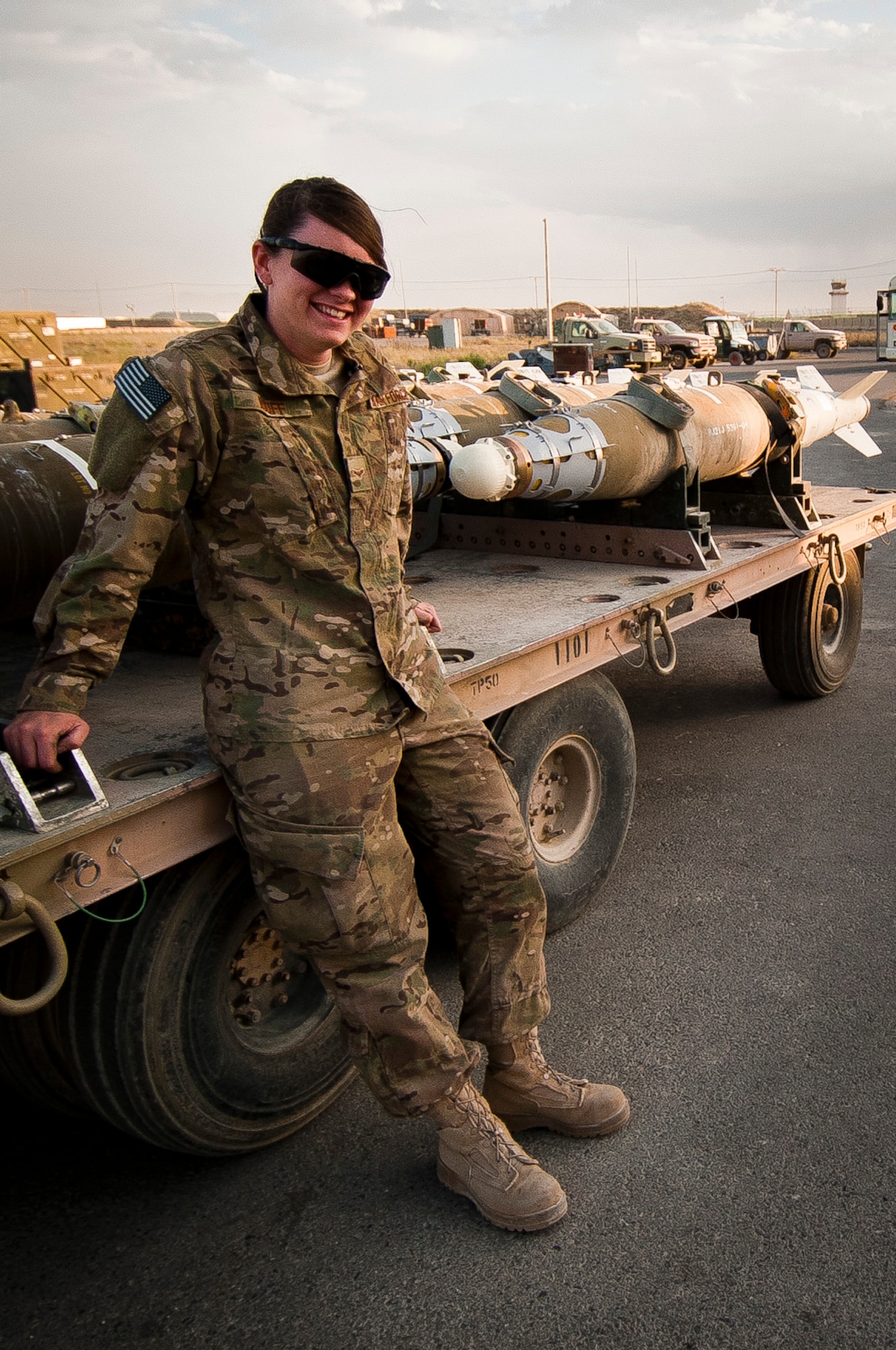 A1C Mary Wiuff, Munitions Systems Specialist with the 455th Maintenance Squadron, stands next to a shipment of GBU-38 smart bombs at Bagram Airfield, Afghanistan, June 23, 2012. Wiuff and her fellow maintainers sustain the fight by providing reliable, precise firepower to BAF’s aircrews. (U.S. Air Force photo/Capt. Raymond Geoffroy)