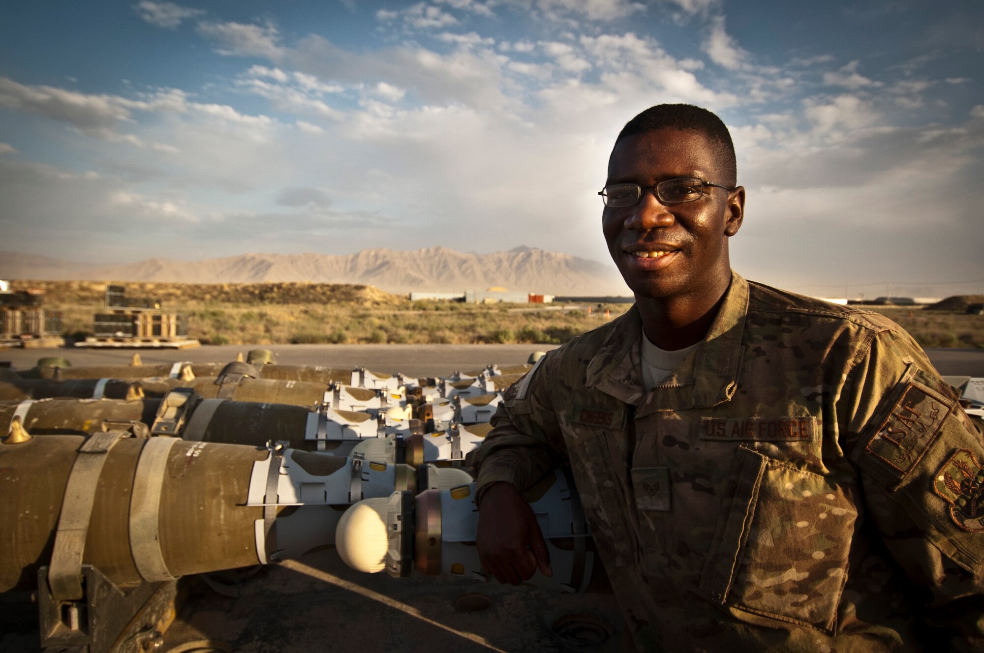 SSgt Bryan Cheeks, Munitions Systems Specialist with the 455th Maintenance Squadron, stands next to a shipment of GBU-38 smart bombs at Bagram Airfield, Afghanistan, June 23, 2012. Cheeks and his fellow maintainers sustain the fight by providing reliable, precise firepower to BAF’s aircrews. (U.S. Air Force photo/Capt. Raymond Geoffroy)