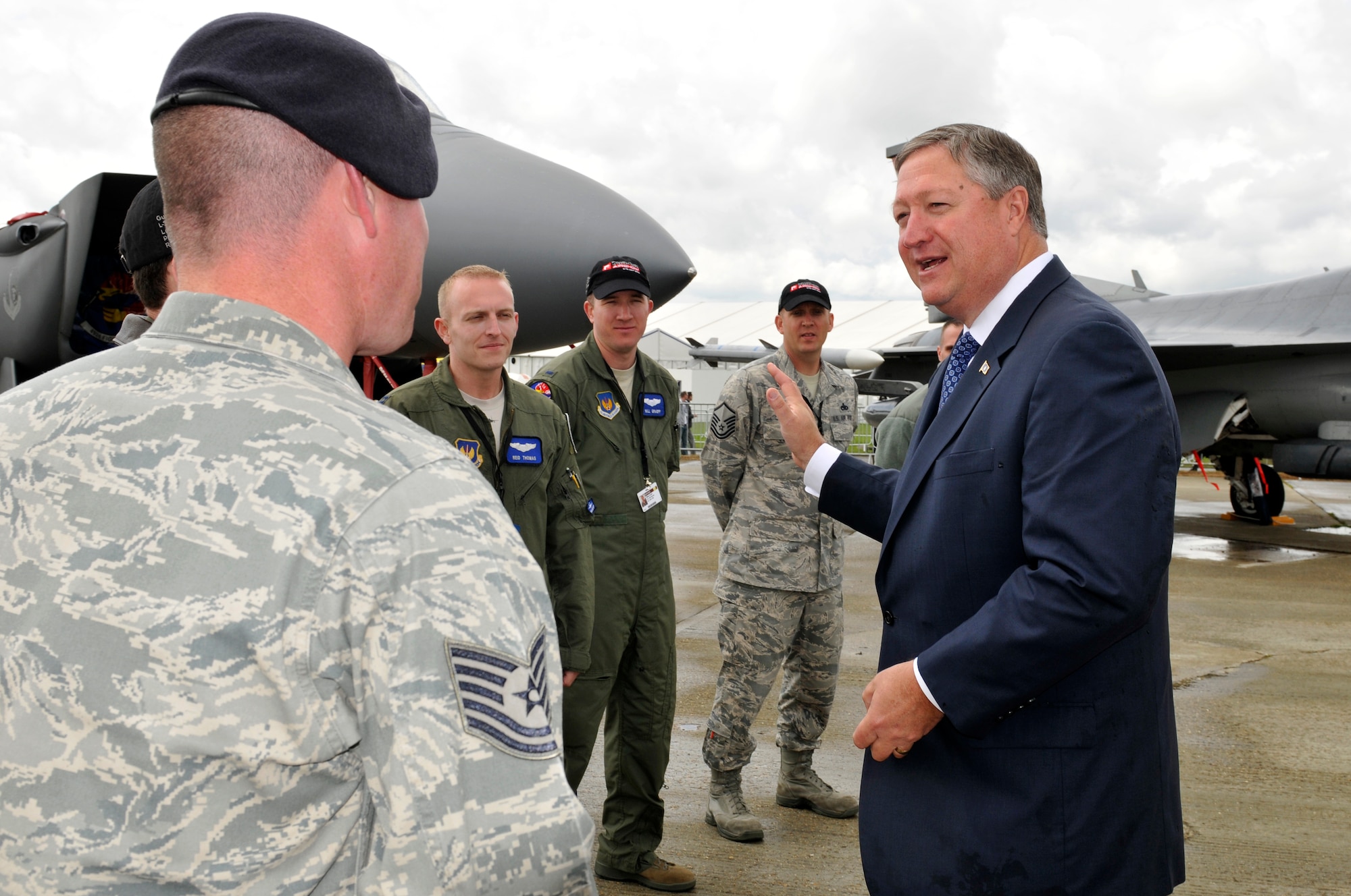 Secretary of the Air Force Michael Donley talks with airmen from Royal Air Force Station Lakenheath July 10, 2012, during a visit to the Farnborough International Air Show in Farnborough, England. Approximately 90 aircrew and support personnel from bases in Europe and the United States are participating in the air show. Participation in this premier event demonstrates that U.S. defense industry offers state-of-the-art capabilities vital for the support and protection of our Allies??? and Partners??? national-security interests.