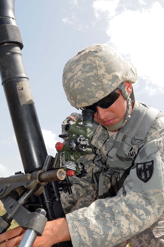 Army Spc. Sylvester Rivera adjusts the sight of his 81mm mortar during annual training at Camp Santiago Joint Maneuver Training Center in Salinas, Puerto Rico, July 11, 2012. Rivera is assigned to the Puerto Rico National Guard 296th Infantry Battalion, 101st Troop Command.