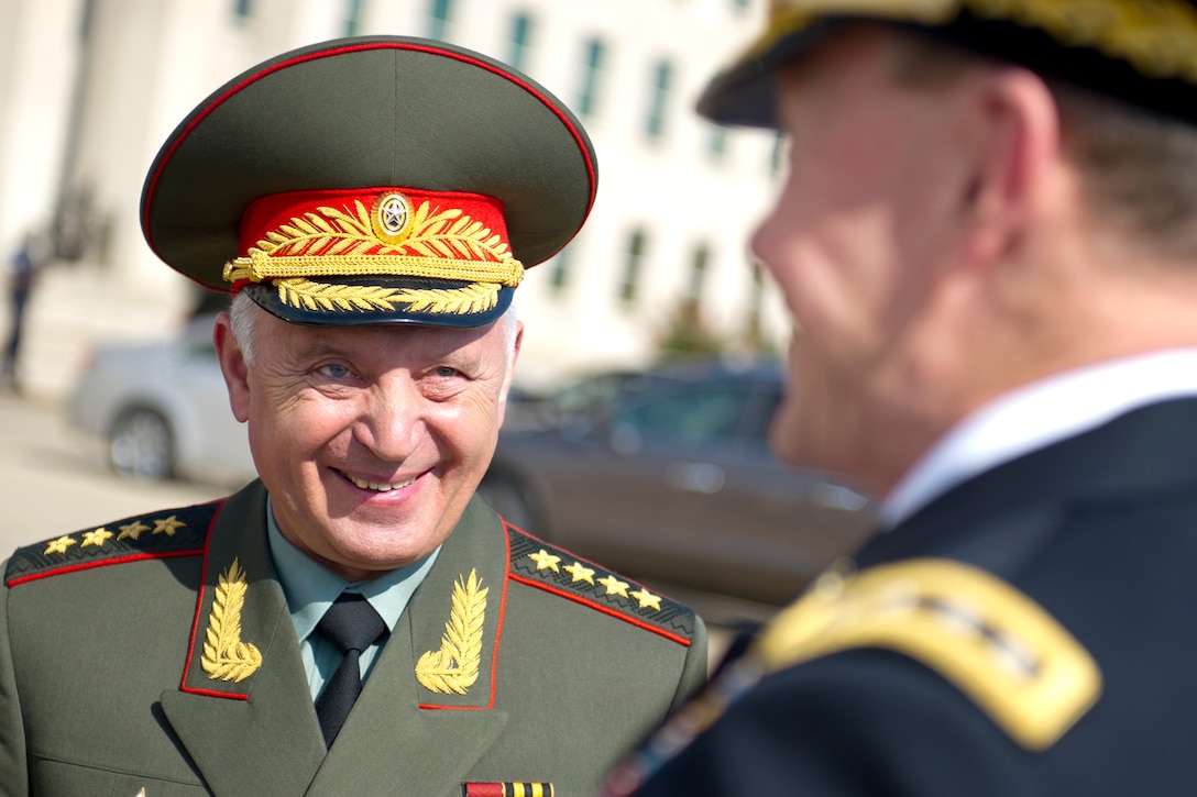 Russian Army Gen. Nikolay Y. Makarov, chief of the Russian general staff and first deputy defense minister general, left, talks with U.S. Army Gen. Martin E. Dempsey, chairman of the Joint Chiefs of Staff, before a full honor cordon at the Pentagon, July 12, 2012.  