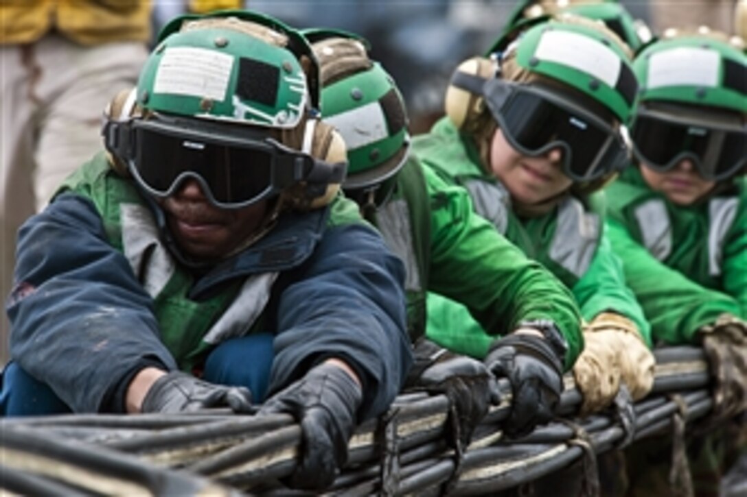 U.S. sailors set up a barricade during flight deck drills aboard the aircraft carrier USS John C. Stennis under way in the Pacific Ocean, July 10, 2012. The John C. Stennis is conducting sustainment exercises designed to maintain mission readiness off the coast of California.