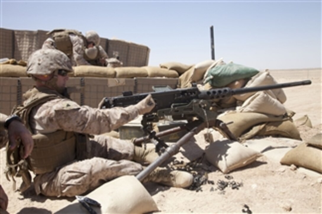 U.S. Marine Corps Cpl. Andrew C. Bell loads ammunition into an M2 .50-caliber heavy machine gun while training at Camp Leatherneck in Helmand province, Afghanistan, on June 28, 2012.  Marines conducted the training to familiarize themselves with different weapons systems.  Bell is assigned to Headquarters Battalion, 1st Marine Division.