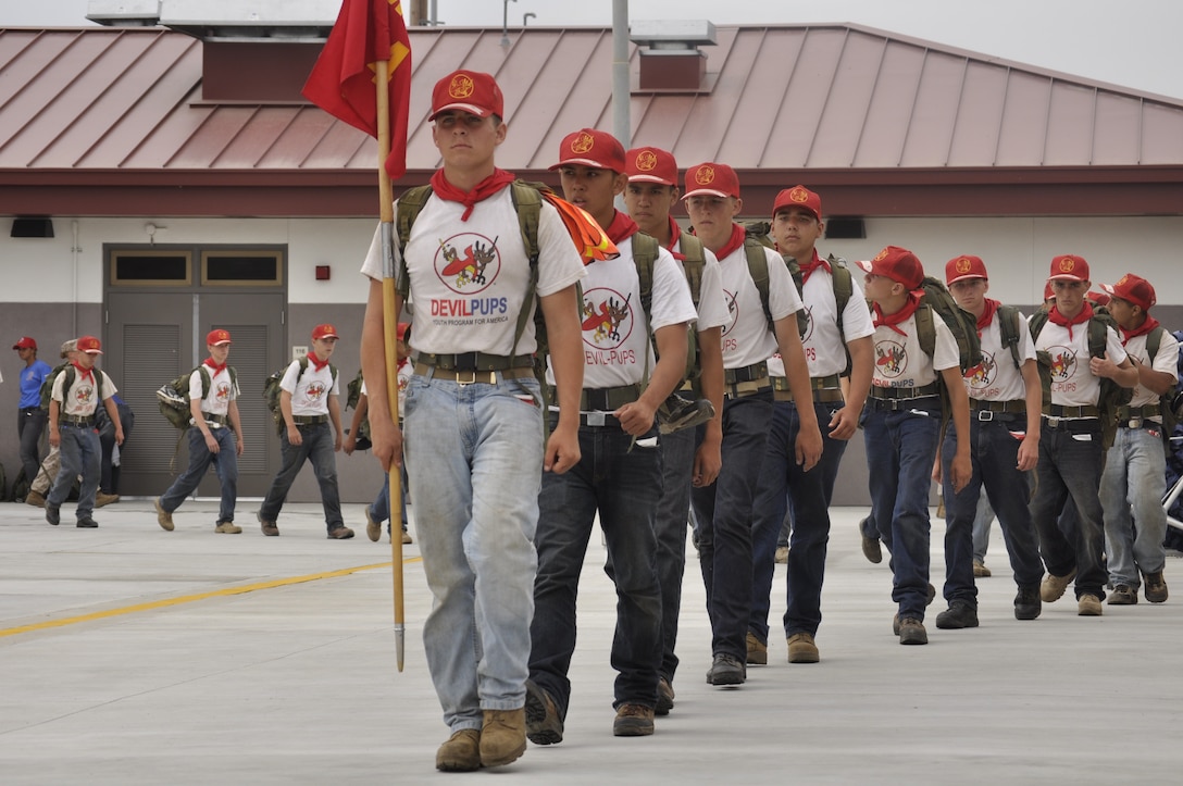 A platoon of Devil Pups march into the Camp Pendleton, 62 Area swimming facility on July 12, which is day eight of their 10 day encampment. One of the graduation requirements is to jump from the 25-foot tower into the pool.