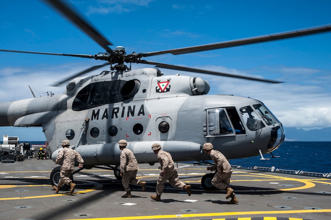 U.S. Marines prepare to enter a Mexican MI-17 aboard the ARM Usumacinta (A-412) during RIMPAC 2012.  Twenty-two nations, more than 40 ships and submarines, more than 200 aircraft and 25,000 personnel are participating in RIMPAC exercise from June 29 to Aug. 3, in and around the Hawaiian Islands. The world's largest international maritime exercise, RIMPAC provides a unique training opportunity that helps participants foster and sustain the cooperative relationships that are critical to ensuring the safety of sea lanes and security on the world's oceans. RIMPAC 2012 is the 23rd exercise in the series that began in 1971.