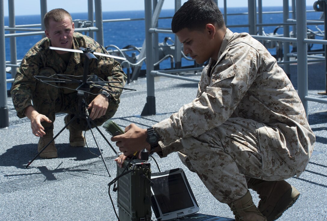 Private David Phelan moves a satcom (Satellite Communication) antenna as Sgt. Vincent Flores checks for signal strength with secure data communication equipment while attempting to acquire a signal on a weather deck aboard the amphibious assault ship USS Essex (LHD 2). Both Marines are assigned to Company A, 3rd Reconnaissance Battalion. Twenty-two nations, more than 40 ships and submarines, more than 200 aircraft and 25,000 personnel are participating in RIMPAC exercise from June 29 to Aug. 3, in and around the Hawaiian Islands.  The world's largest international maritime exercise, RIMPAC provides a unique training opportunity that helps participants foster and sustain the cooperative relationships that are critical to ensuring the safety of sea lanes and security on the world's oceans. RIMPAC 2012 is the 23rd exercise in the series that began in 1971. 