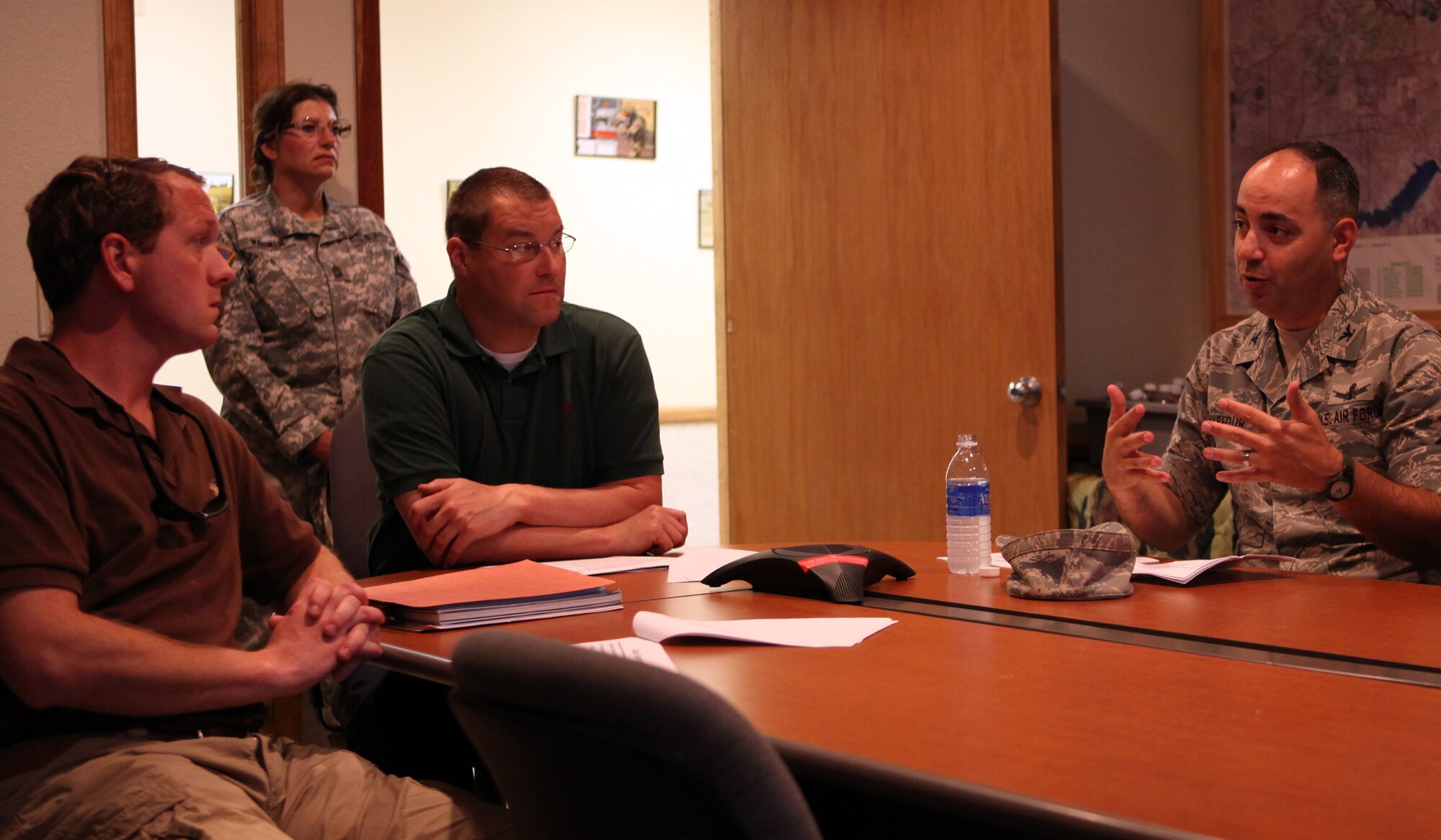 Col. George Farfour, 90th Missile Wing vice commander, speaks with Charles Ziegler, military liaison assistant to Senator John Barrasso, and Michael Stransky, policy analyst for nuclear studies, in the conference room at Camp Guernsey, Wyo. June 2. The visit included tours of Camp Guernsey, missile alert facility Echo-01, missile maintenance training facility Uniform-01, and demonstrations by 90th Security Forces Group tactical response force and military working dogs. (U.S. Air Force photo by Matt Bilden)