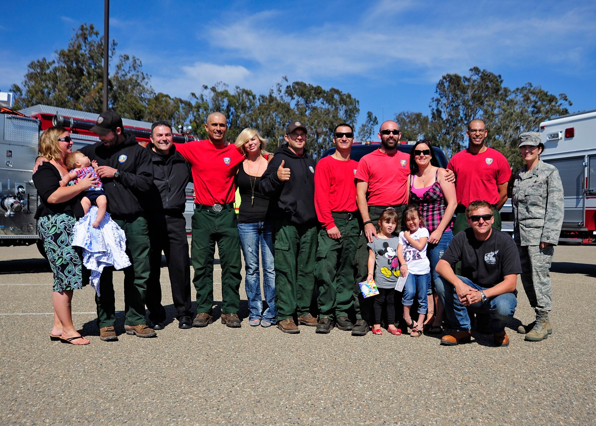 The final eight members of Vandenberg's Hot Shots crew and their families pose with Col. Nina Armagno, 30th Space Wing commander, and other members of Vandenberg's Fire Department, after returning to base Friday, July 13. The Vandenberg Hot Shot crew spent more than two weeks fighting the wildland fires that devastated Colorado and Wyoming. On their return home, this Hot Shots crew also witnessed a United Parcel Service truck lose control and flip off of the highway. First on scene, the Hot Shots provided first aid and controlled the scene until the California Highway Patrol could respond.
(U.S. Air Force photo/Michael Peterson) 
