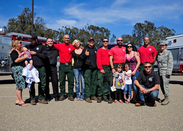 The final eight members of Vandenberg's Hot Shots crew and their families pose with Col. Nina Armagno, 30th Space Wing commander, and other members of Vandenberg's Fire Department, after returning to base Friday, July 13. The Vandenberg Hot Shot crew spent more than two weeks fighting the wildland fires that devastated Colorado and Wyoming. On their return home, this Hot Shots crew also witnessed a United Parcel Service truck lose control and flip off of the highway. First on scene, the Hot Shots provided first aid and controlled the scene until the California Highway Patrol could respond.
(U.S. Air Force photo/Michael Peterson) 
