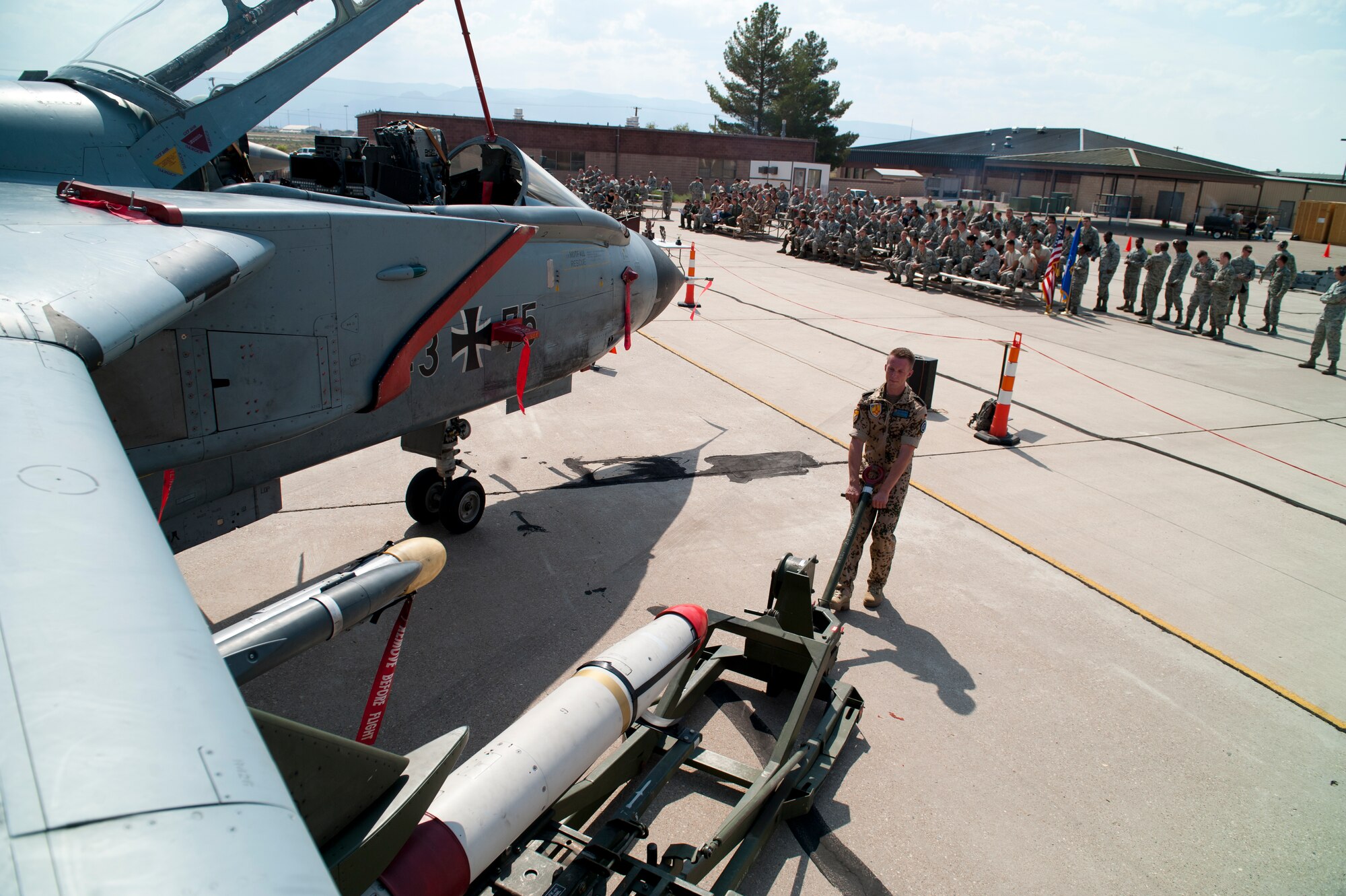 German Air Force Tech. Sgt. Carsten Wedemeyer, German Air Force Flying Training Center, prepares an AIM-9 sidewinder to be loaded onto a Tornado during a quarterly load-crew competition at Holloman Air Force Base, N.M., July 13. The crew loaded a GBU-32 bomb and an AIM-9 Sidewinder during the competition to display their warfighting skills, while avoiding safety and procedural errors. The GAF crew also competed against U.S. Air Force F-22 Raptor and MQ-9 Reaper load crews. (U.S. Air Force photo by Airman First Class Daniel Liddicoet/Released)