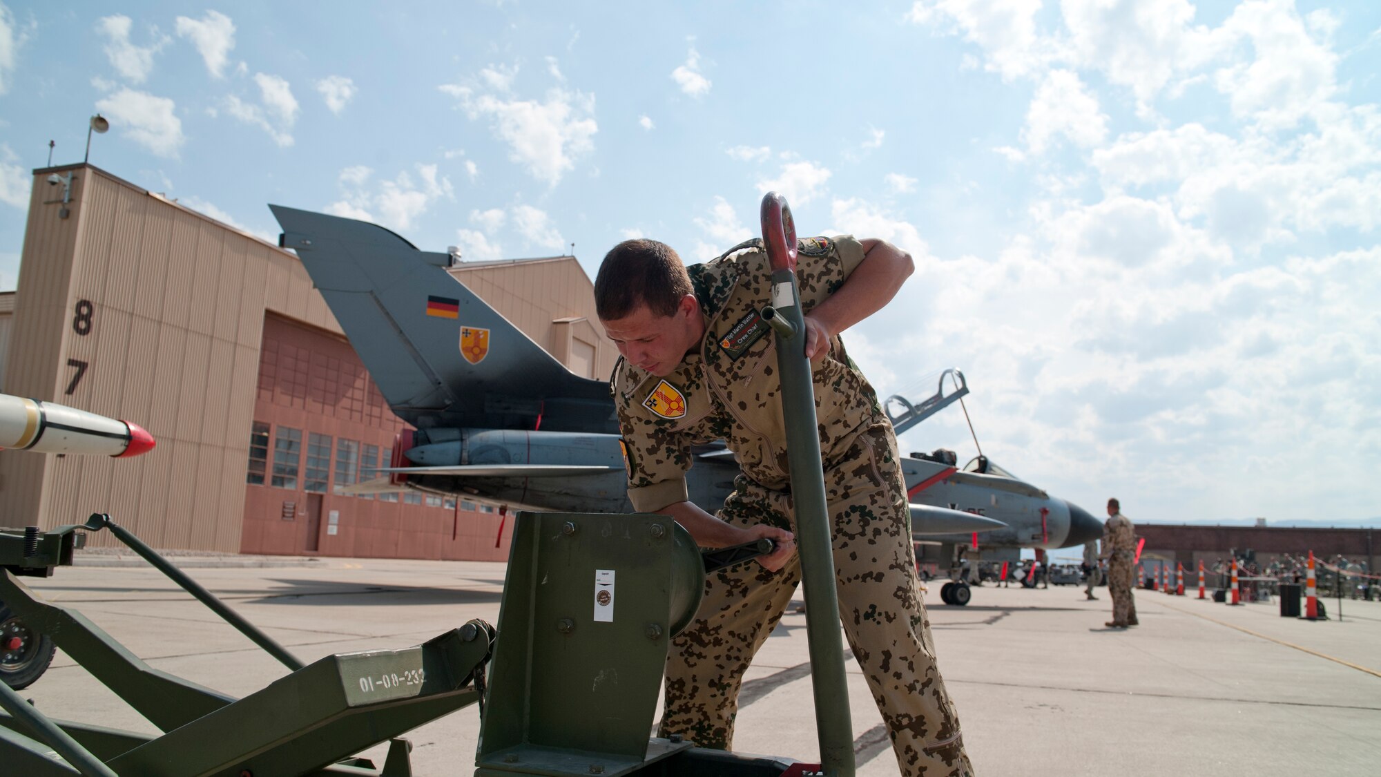 German Air Force Tech. Sgt. Martin Wattler, German Air Force Flying Training Center crew chief, prepares an AIM-9 Sidewinder missile to be loaded onto a Tornado during a quarterly load-crew competition at Holloman Air Force Base, N.M., July 13. The crew loaded a GBU-32 bomb and an AIM-9 during the competition to display their warfighting skills, while avoiding safety and procedural errors. The GAF crew also competed against U.S. Air Force F-22 Raptor and MQ-9 Reaper load crews. (U.S. Air Force photo by Airman First Class Daniel Liddicoet/Released)