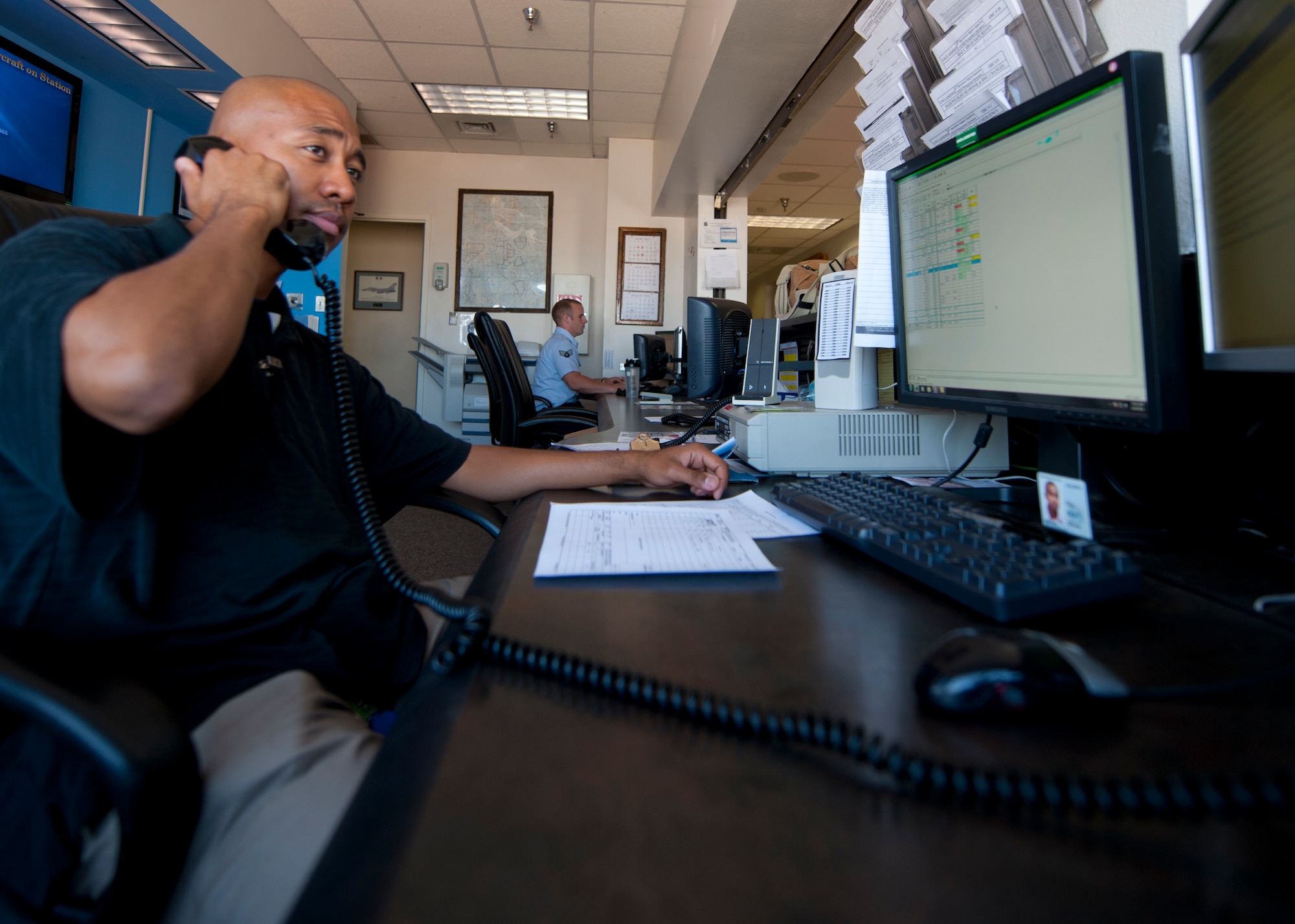 Julius Griffin, 49th Operations Support Squadron airfield manager, fields a phone call from the air traffic control tower at Holloman Air Force Base, N.M., June 26. Communications with air traffic control is an integral part of an airfield manager’s job. Airfield managers are responsible for relaying all the information they receive from air traffic control to the proper authorities. (U.S. Air Force photo by Airman 1st Class Daniel E. Liddicoet/Released)