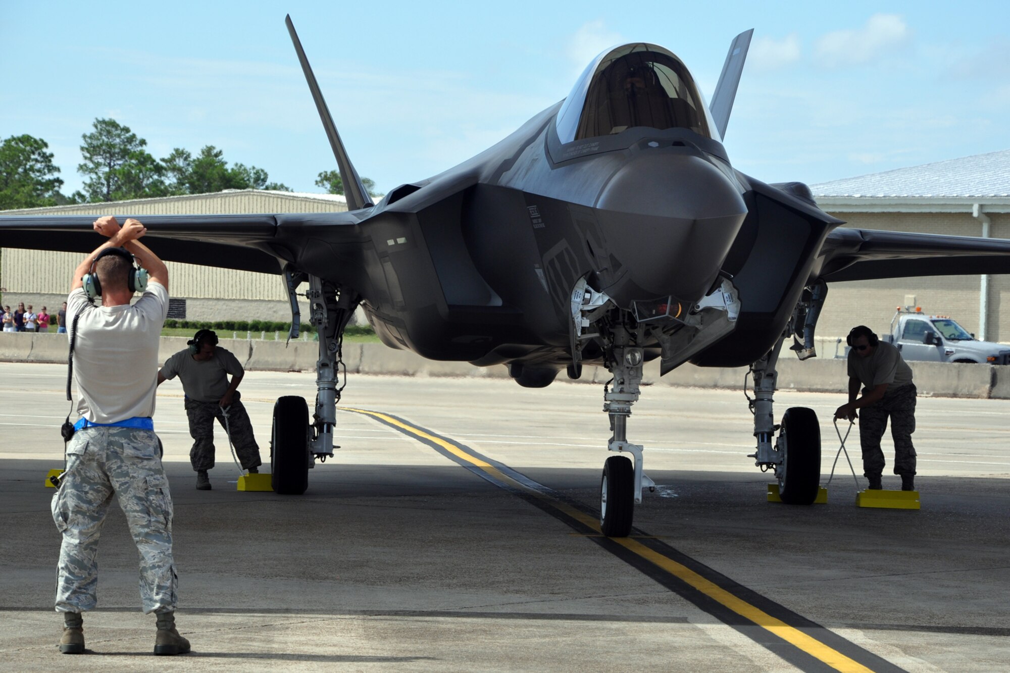EGLIN AIR FORCE BASE, Fla. -- A crew chief with the 33rd Fighter Wing and pilot conduct the post flight shut down of an a F-35A Lightning II July 13. With three F-35As arriving today, the wing increased the fleet to 16 F-35 A and B variants combined. This week also marks the 100th sortie of an F-35 at Eglin with a Marine Fighter Attack Training Squadron 501 flight July 11. The wing received its first F-35 July 14, 2011 and continues to qualify Air Force and Marine Corps initial cadre as instructor pilots. (U.S. Air Force photo by Maj. Karen Roganov)