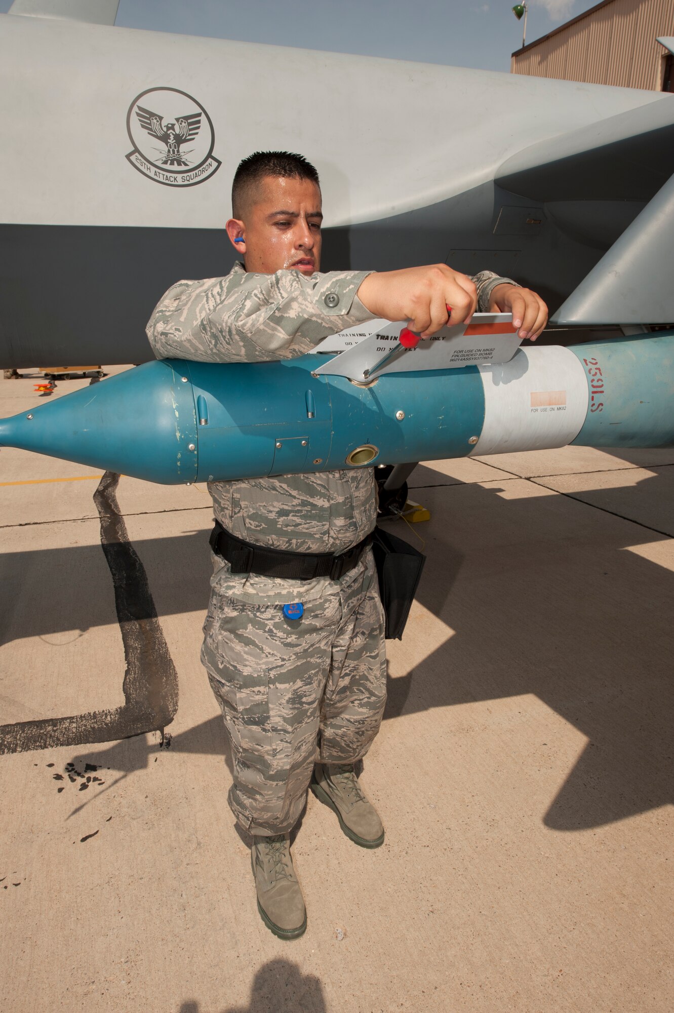 Staff Sgt. Gabrial [last name withheld due to operational security concerns], 49th Maintenance Group, tightens a piece on a GBU-12 laser-guided bomb during a quarterly load-crew competition at Holloman Air Force Base N.M., July 13. For load-crew competitions, points are awarded during the actual weapons loading, a tool-kit inspection, and a uniform inspection. The competitions are held to give weapons personnel the opportunity to display their warfighting skills and to unveil the best weapons load crew for a particular quarter during the year. (U.S. Air Force photo by Airman Leah Ferrante/Released)