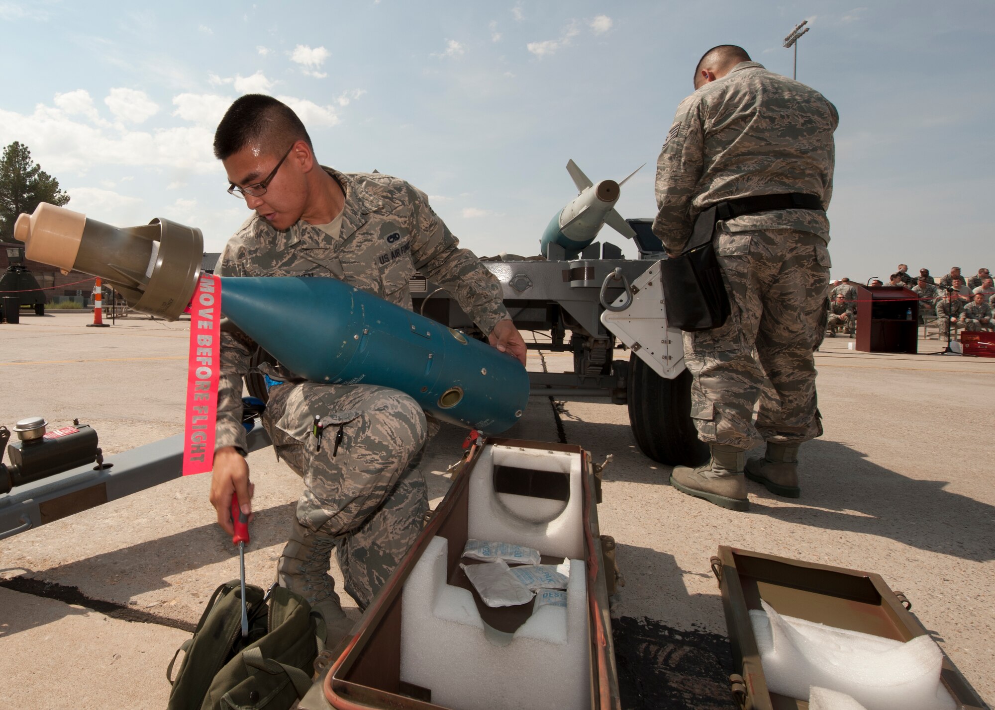 Airman 1st Class Binh [last name withheld due to operational security concerns], 49th Maintenance Group, prepares a GBU-12 laser-guided bomb to be loaded onto an MQ-9 Reaper during a quarterly load-crew competition at Holloman Air Force Base N.M., July 13. For the competition, three load teams competed against each other to determine who can load weaponry onto their aircraft quickly, without safety or mechanical errors. Nguyen’s MQ-9 crew competed against crews from the F-22 Raptor and German Tornado platforms for the title of Holloman’s best weapons load crew. (U.S. Air Force photo by Airman Leah Ferrante/Released)
