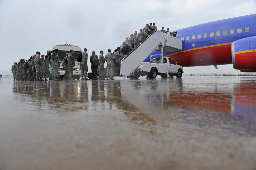 Airmen with temporary duty orders to Nellis Air Force Base, Nev., board a chartered flight on Barksdale Air Force Base, La., July 12. About 157 maintenance, force support and logistics Airmen along with aircrews left for Nellis to participate in the Red Flag exercise. Red Flag provides realistic combat scenarios for aircrews from the U.S., NATO and allied countries. (U.S. Air Force photo/Airman 1st Class Micaiah Anthony)(RELEASED)