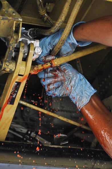 Senior Airman Kern Brathwaite, 2nd Aircraft Maintenance Squadron aircraft pneudraulics journeyman, connects a hydraulic line to a spoiler actuator on Barksdale Air Force Base, La., July 11. Brathwaite had to replace a spoiler actuator in order for the B-52H Stratofortress to participate in the Red Flag exercise at Nellis AFB, Nev. Maintenance Airmen worked around-the-clock to ensure all aircraft participating in the exercise were ready. Red Flag provides realistic combat scenarios for aircrews from the U.S., NATO and allied countries. (U.S. Air Force photo/Airman 1st Class Micaiah Anthony)(RELEASED)