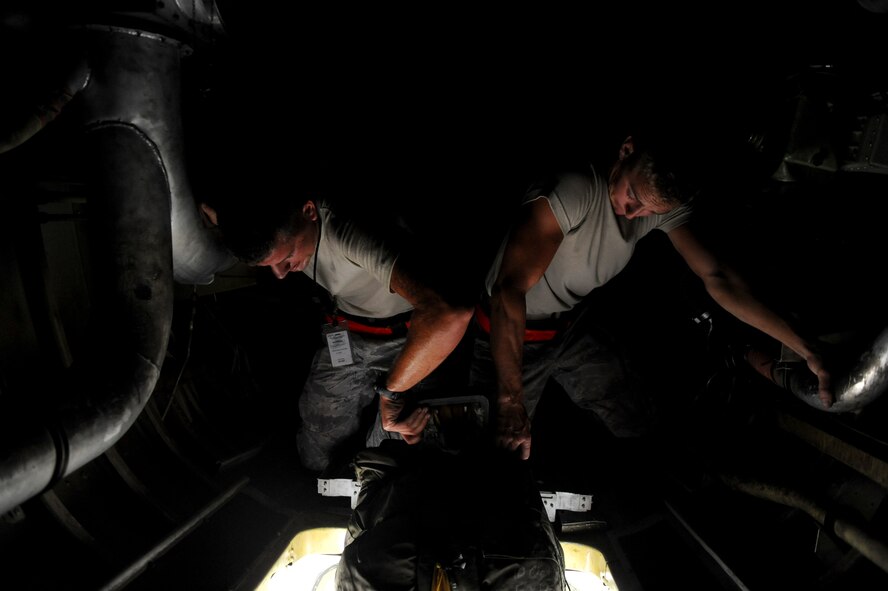 Airmen 1st Class Benjamin Deachin (left) and Jeremy Gorman, 2nd Aircraft Maintenance Squadron crew chiefs, pull a drag chute into the tail section of a B-52H Stratofortress on Barksdale Air Force Base, La., July 11. Extra oil, hydraulic fluid, chalks, drag chutes and parachutes were loaded into B-52Hs participating in the Red Flag exercise at Nellis AFB, Nev. Maintenance equipment, tools and aircraft parts where shipped to Nellis earlier in the week to support the incoming B-52Hs. (U.S. Air Force photo/Airman 1st Class Micaiah Anthony)(RELEASED)