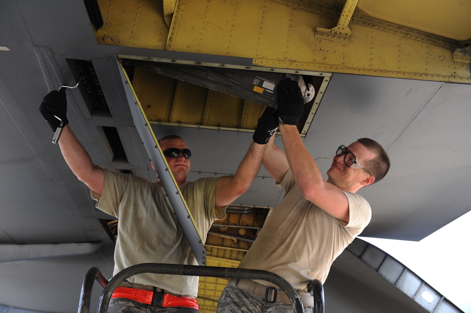 Senior Airmen Benjamin Cooper (left) and Beau Potter, 2nd Aircraft Maintenance Squadron electronic warfare journeymen, unload chaff from a B-52H Stratofortess on Barksdale Air Force Base, La., July 11. Only B-52Hs not participating in the Red Flag exercise at Nellis AFB, Nev., had their chaff removed. Airmen loaded the remaining chaff onto B-52Hs departing for the exercise to save the Air Force money. Red Flag provides realistic combat scenarios for aircrews from the U.S., NATO and allied countries. (U.S. Air Force photo/Airman 1st Class Micaiah Anthony)(RELEASED)