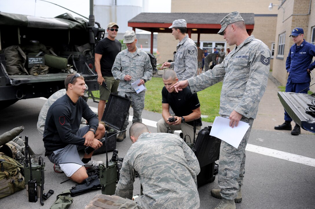 New York Air National Guard Tech. Sgt. Jason Hancock (foreground right) from the 274th Air Support Operations Squadron out of Hancock Field Air National Guard Base, Syracuse, New York instructs Airmen from the 274th on various communications equipment at the U.S. Coast Guard station in Oswego on June 18, 2012.  The communications equipment was used during training missions on Lake Ontario where the 274th worked with a MQ-9 Reaper remotely piloted aircraft out of Hancock Field.  This was a joint operation with the U.S. Coast Guard, N.Y. Naval Militia and the 174th Fighter Wing to train in different maritime rescue operations where an RPA could assist. (New York Air National Guard photo by Tech. Sgt. Jeremy M. Call/Released)