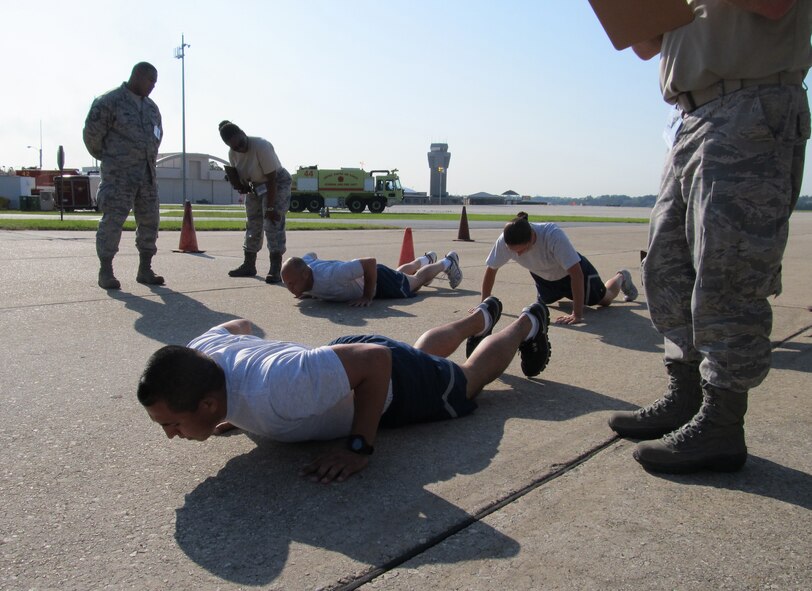 Master Sgt. Roger Hauch, Staff Sgt. Daniel Sanchez and Senior Airman Emily Erickson perform burpees during the fitness challenge event at the Port Dawg Challenge June 18-25 at Dobbins Air Reserve Base, Ga. The three were part of the 934th Airlift Wing team that won two events in the competition. (U.S. Air Force photo/Senior Airman Stephanie Graybill) 
