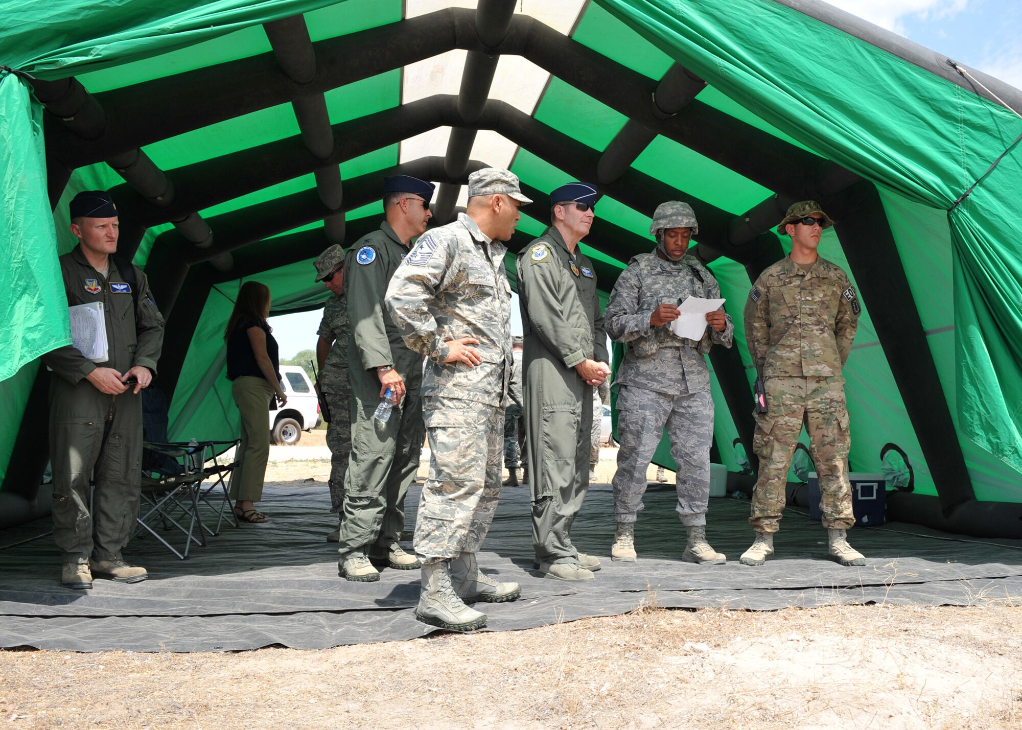 U.S. Air Force Lt. Gen. Robin Rand, 12th Air Force commander, and Chief Master Sgt. Gerardo Tapia Jr., 12th AF command chief, gathers with Gunfighters to view a deployed environment demonstration July 11, 2012, at Mountain Home Air Force Base, Idaho. The demonstration was held to show the camaraderie between units to accomplish the mission. (U.S. Air Force photo/Airman 1st Class Heather Hayward)