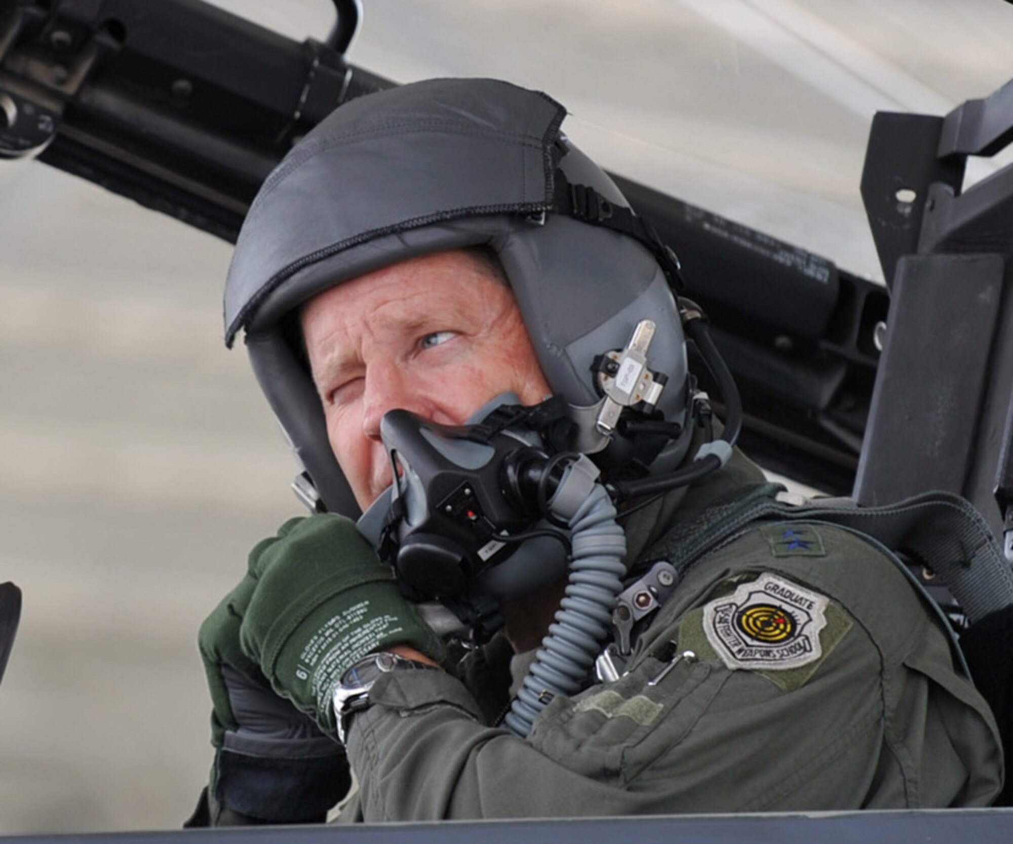 U.S. Air Force Lt. Gen. Robin Rand, 12th Air Force commander, adjusts his bayonet while preparing to don his aviator mask prior to his familiarization flight July 11, 2012, at Mountain Home Air Force Base, Idaho. While Rand was here, he had the opportunity to visit places such as the 366th Medical Group, 428th Fighter Squadron, the 366th Maintenance Group, and host a trio of commander’s calls. (U.S. Air Force photo/Airman 1st Class Heather Hayward)