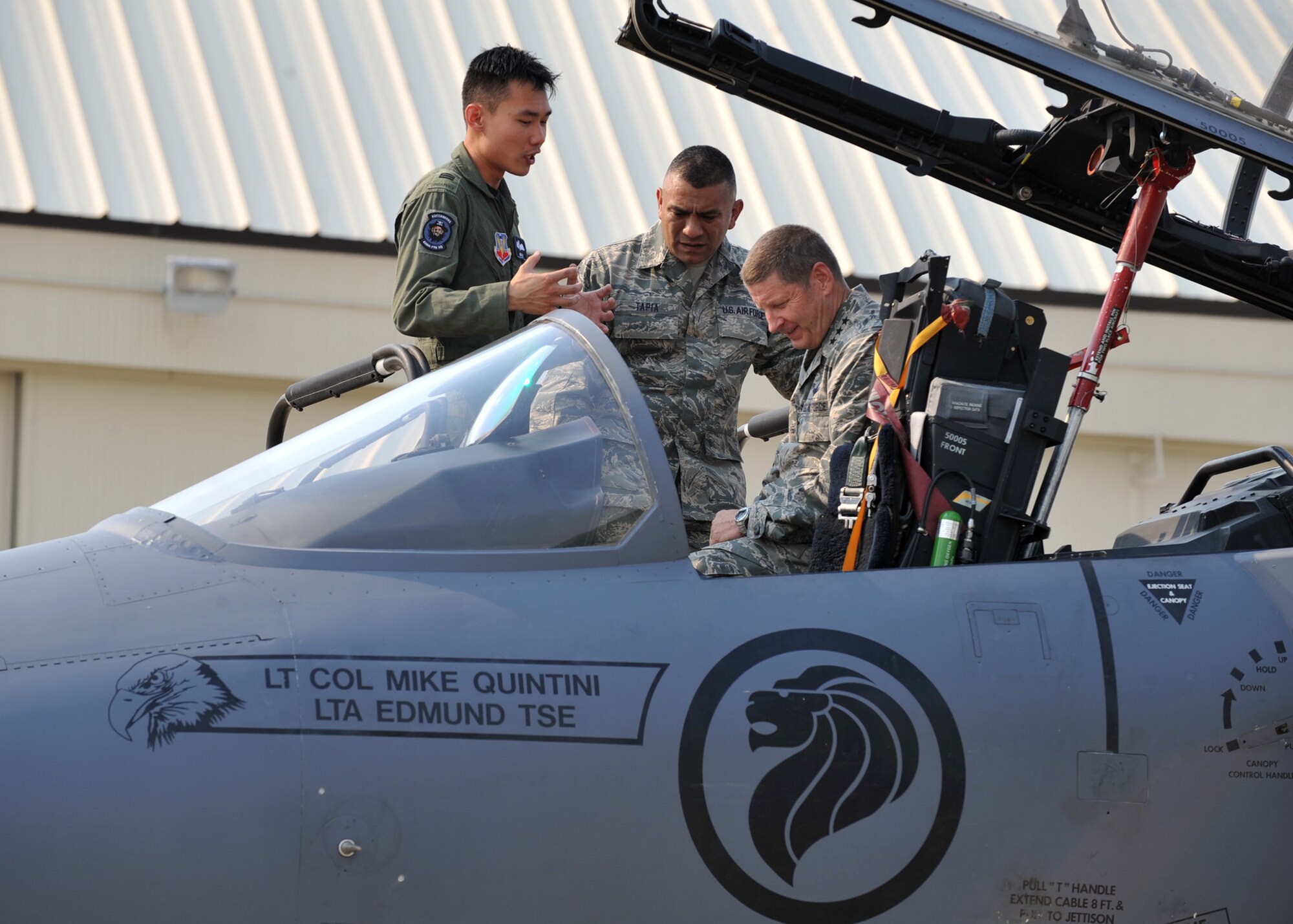 A member of the 428th Fighter Squadron shows U.S. Air Force Lt. Gen. Robin Rand and Chief Master Sgt. Gerardo Tapia Jr. the cockpit of an F-15SG July 10, 2012, at Mountain Home Air Force Base, Idaho. The Republic of Singapore air force is expected to have a detachment here for the next 22 years. (U.S. Air Force photo/Airman 1st Class Heather Hayward)