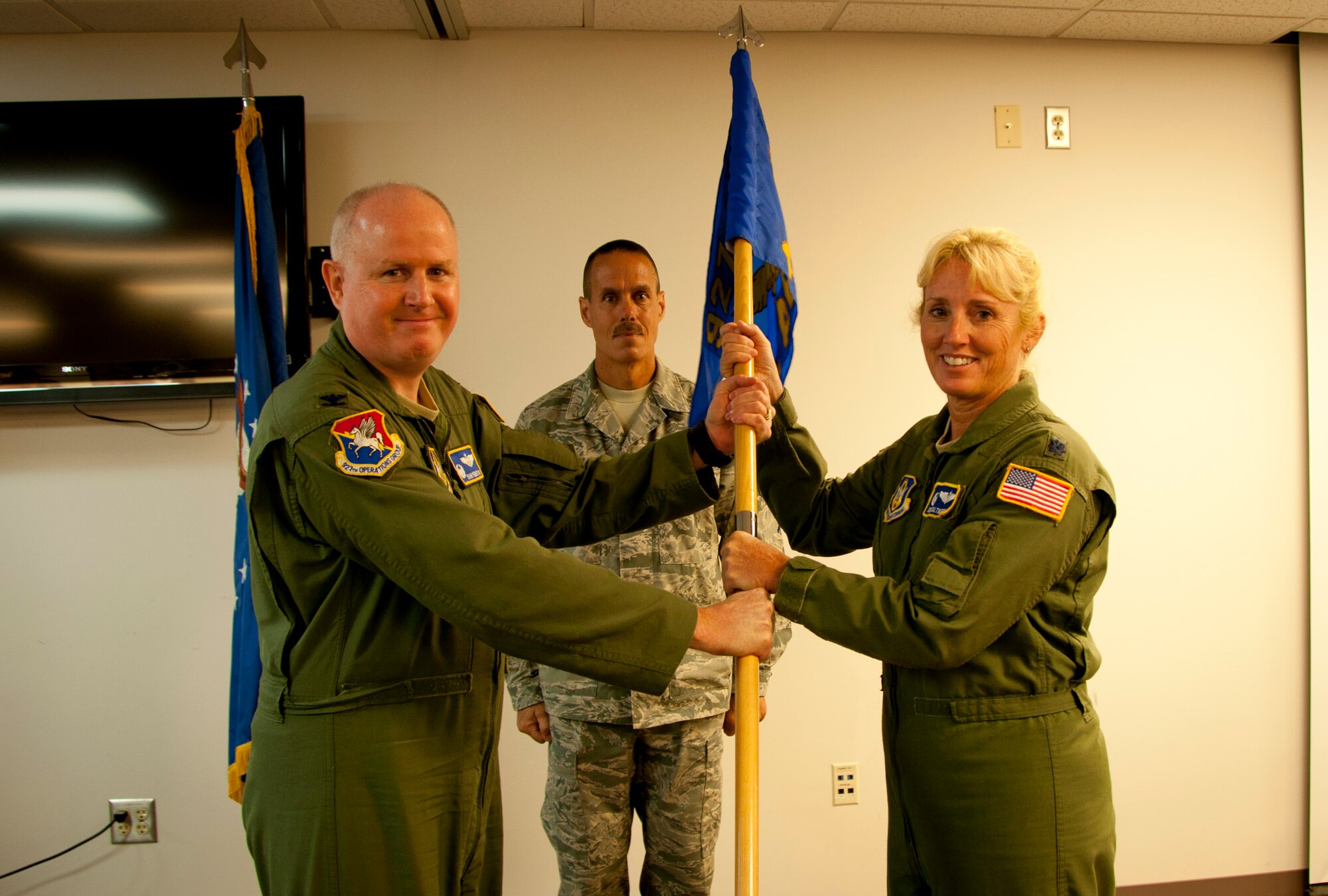 Colonel Thomas Pemberton, commander, 927th Operations Group, hands over the unit guidon of the 45th Aeromedical Evacuation Squadron to Lt. Col. Deborah Saltmarsh during an assumption of command ceremony here July 13, 2012. Saltmarsh assumed command of the reserve unit whose mission involves in-flight medical care of wounded troops. (Official U.S. Air Force photo/Staff Sgt. Shawn Rhodes)