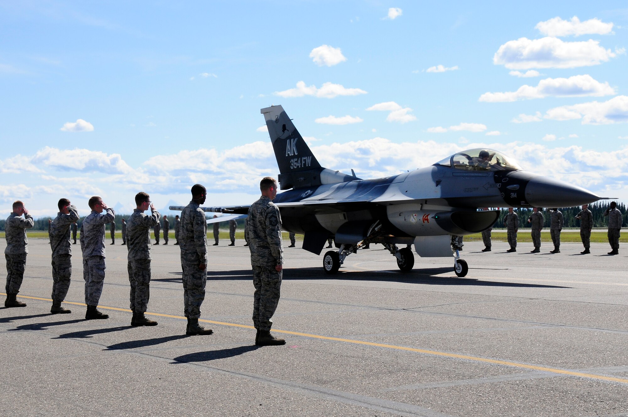 Members of the Iceman Team render a salute to Brig. Gen. James N. Post III, 354th Fighter Wing commander, as he taxis down the flight line upon completion of his final flight July 12, Eielson Air Force Base, Alaska. Post will move on from the 354th FW to serve as Deputy Director, Operations, Plans, Programs and Requirements, Headquarters Pacific Air Forces, Joint Base Pearl Harbor-Hickam, Hawaii. (U.S. Air Force photo/Airman 1st Class Zachary Perras)