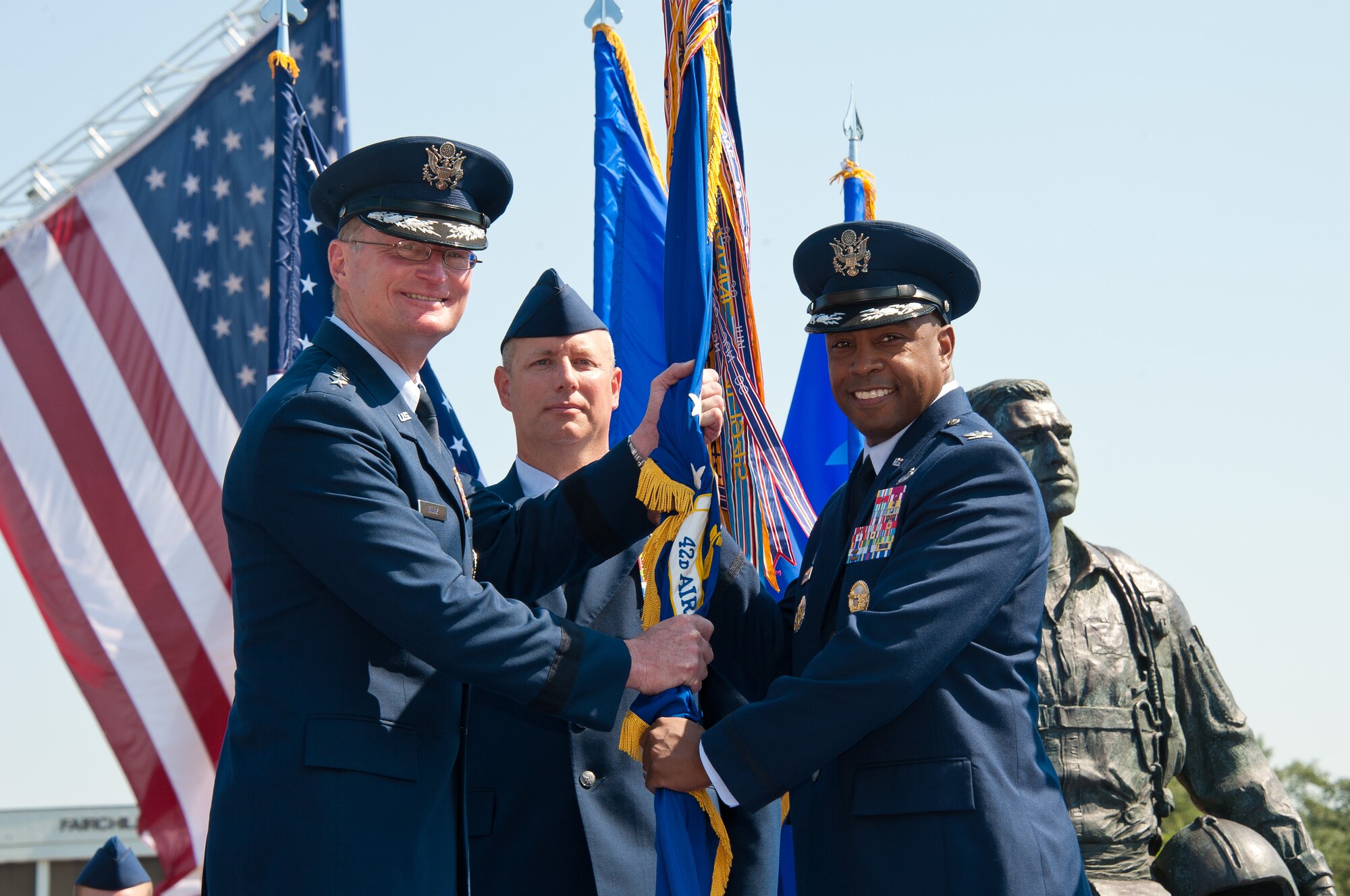 Lt. Gen. David Fadok, commander and president of the Air University passes the colors to Col. Trent Edwards as Col. Edwards assumed command of the 42nd Air Base Wing on June 28. (Air Force photo by Melanie Rodgers Cox)