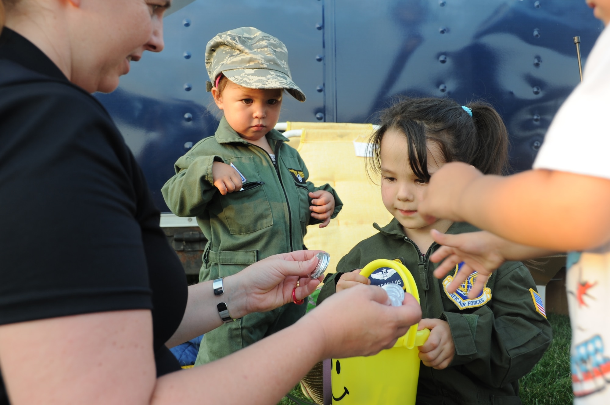 From left, Nichole, 2, and Emily Trimillos, 4, gather keepsakes for young Air Force recruits during the annual Fourth of July celebration at Doughboy Field July 4 here. Nichole and Emily are daughters of Lt. Col. Ricardo Trimillos, 314th Recruiting Squadron commander. (U.S. Air Force photo by Staff Sgt. David Carbajal/Released)
