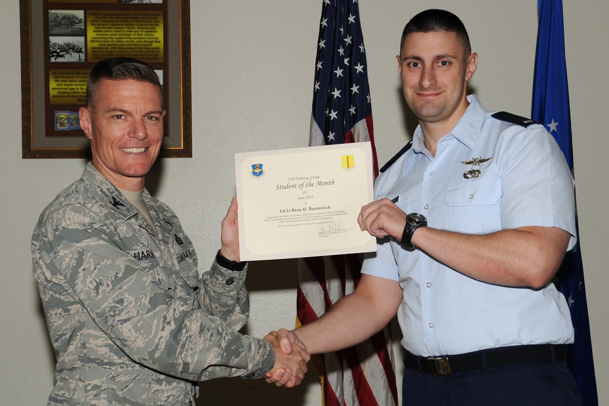 GOODFELLOW AIR FORCE BASE, Texas--  Col. Brendan Harris, 17th Training Group Commander, presents 1st Lt. Beau Brunswick with the 315th Training Squadron Officer Student of the Month award for June at Goodfellow Air Force Base, Texas, July 13, 2012. (U.S. Air Force photo/Staff Sgt. Laura R. McFarlane)