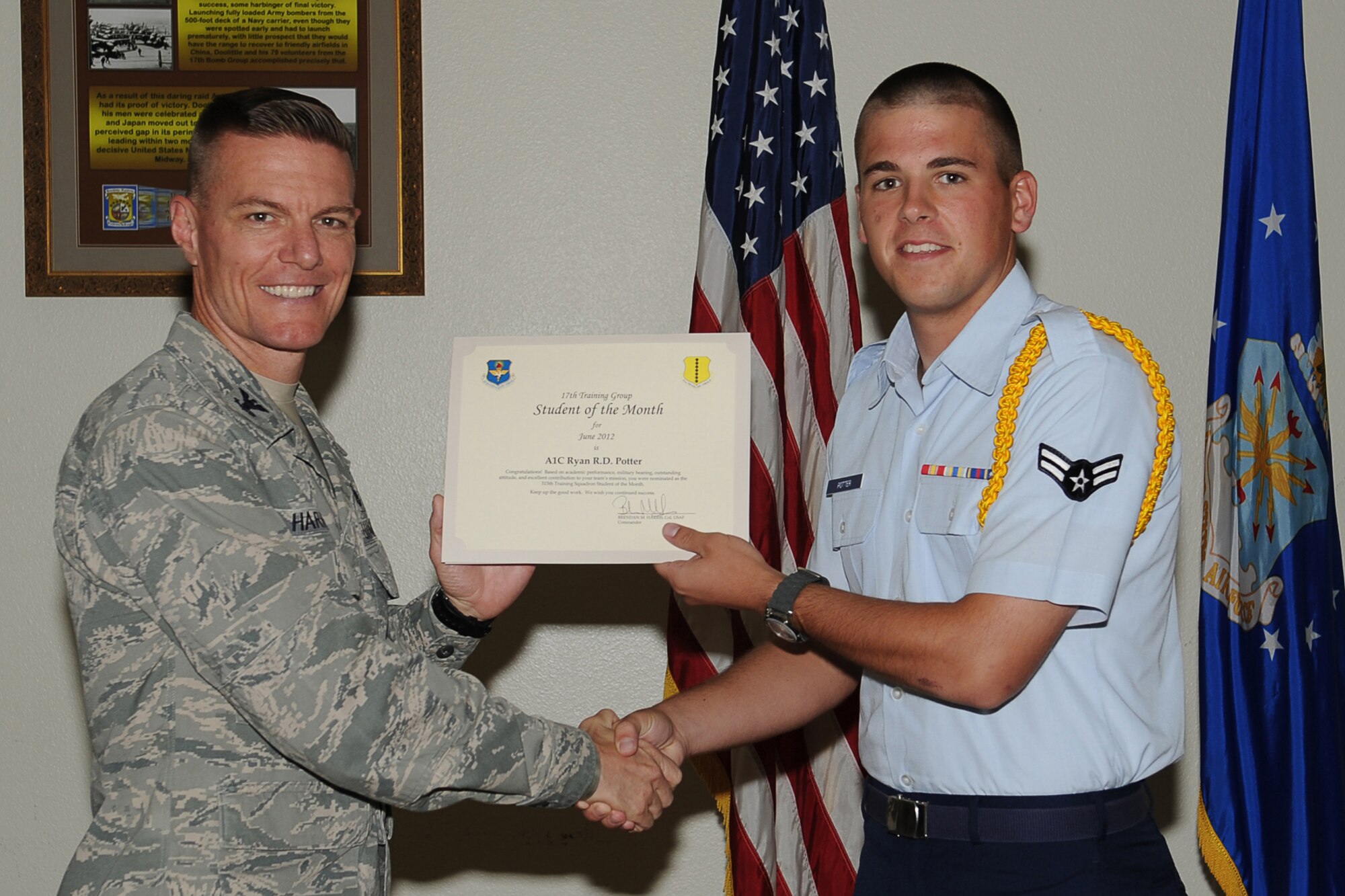 GOODFELLOW AIR FORCE BASE, Texas-- Col. Brendan Harris, 17th Training Group Commander, presents Airman 1st Class Ryan Potter with the 315th Training Squadron Enlisted Student of the Month award for June at Goodfellow Air Force Base, Texas, July 13, 2012. (U.S. Air Force photo/Staff Sgt. Laura R. McFarlane)