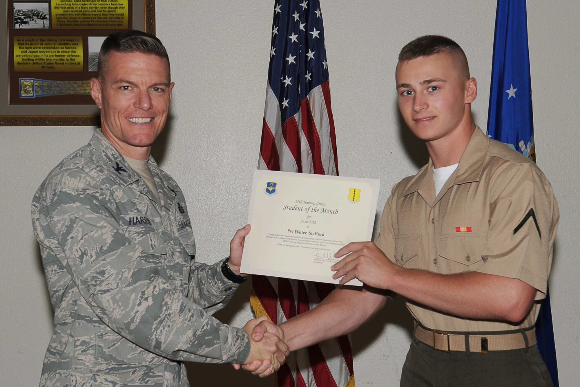 GOODFELLOW AIR FORCE BASE, Texas-- Col. Brendan Harris, 17th Training Group Commander, presents Marine Corps Pvt. Dalten Stafford with the 312th Training Squadron Student of the Month award for June at Goodfellow Air Force Base, Texas, July 13, 2012. (U.S. Air Force photo/Staff Sgt. Laura R. McFarlane)