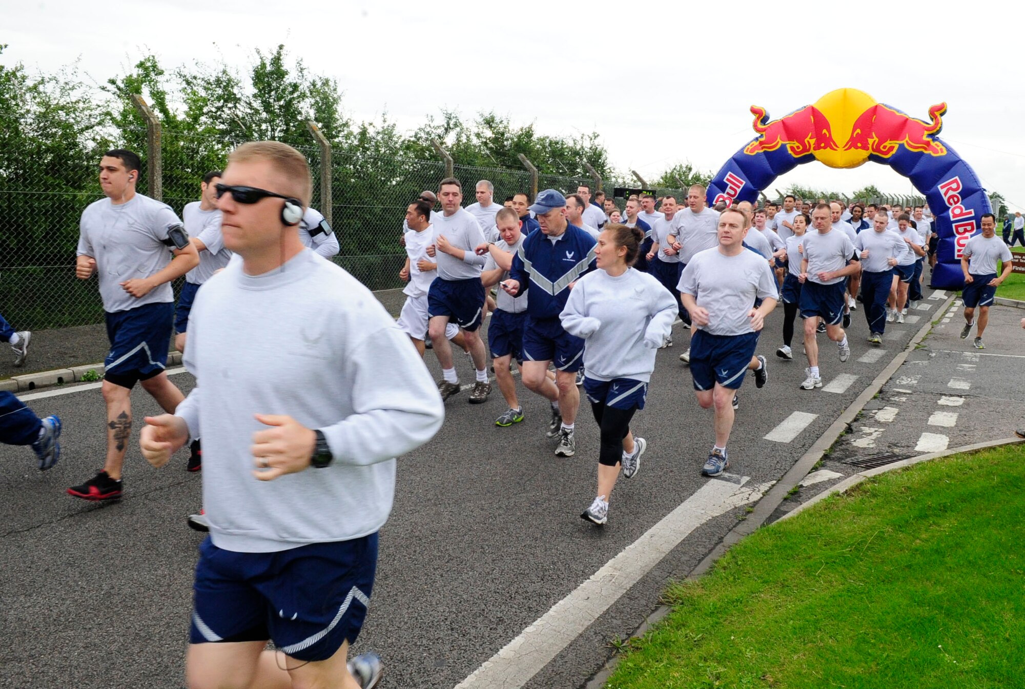 RAF MILDENHALL, England – Participants of the July Team Mildenhall Fun Run begin the friendly race July 13, 2012. The monthly five-kilometer run is open to all family members, including the four-legged variety, and is meant to be a fun way for the base to improve fitness. (U.S. Air Force photo/Senior Airman Ethan Morgan)
