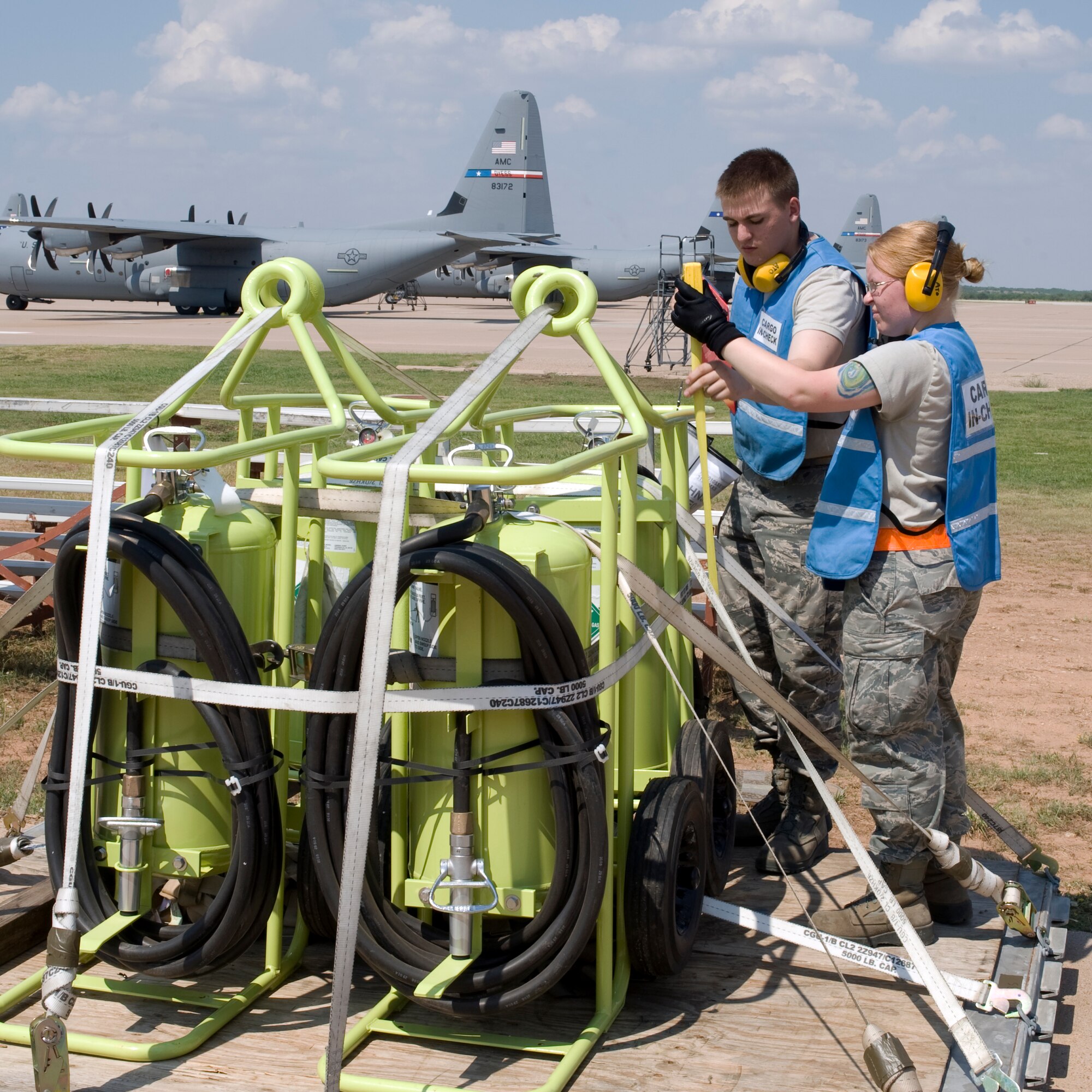 Airman 1st Class Zachary West, left, and Airman 1st Class Nichole Reich, 7th Logistics Readiness Squadron, measure a cargo pallet during an Operational Readiness Exercise July 12, 2012, at Dyess Air Force Base, Texas. Processing cargo quickly and accurately is a vital part of getting the equipment where it needs to be.  Airmen from the 7th LRS must ensure the cargo is weighed properly, secure and safe before it is loaded on the aircraft. (U.S. Air Force photo by Staff Sgt. Richard P. Ebensberger/ Released)