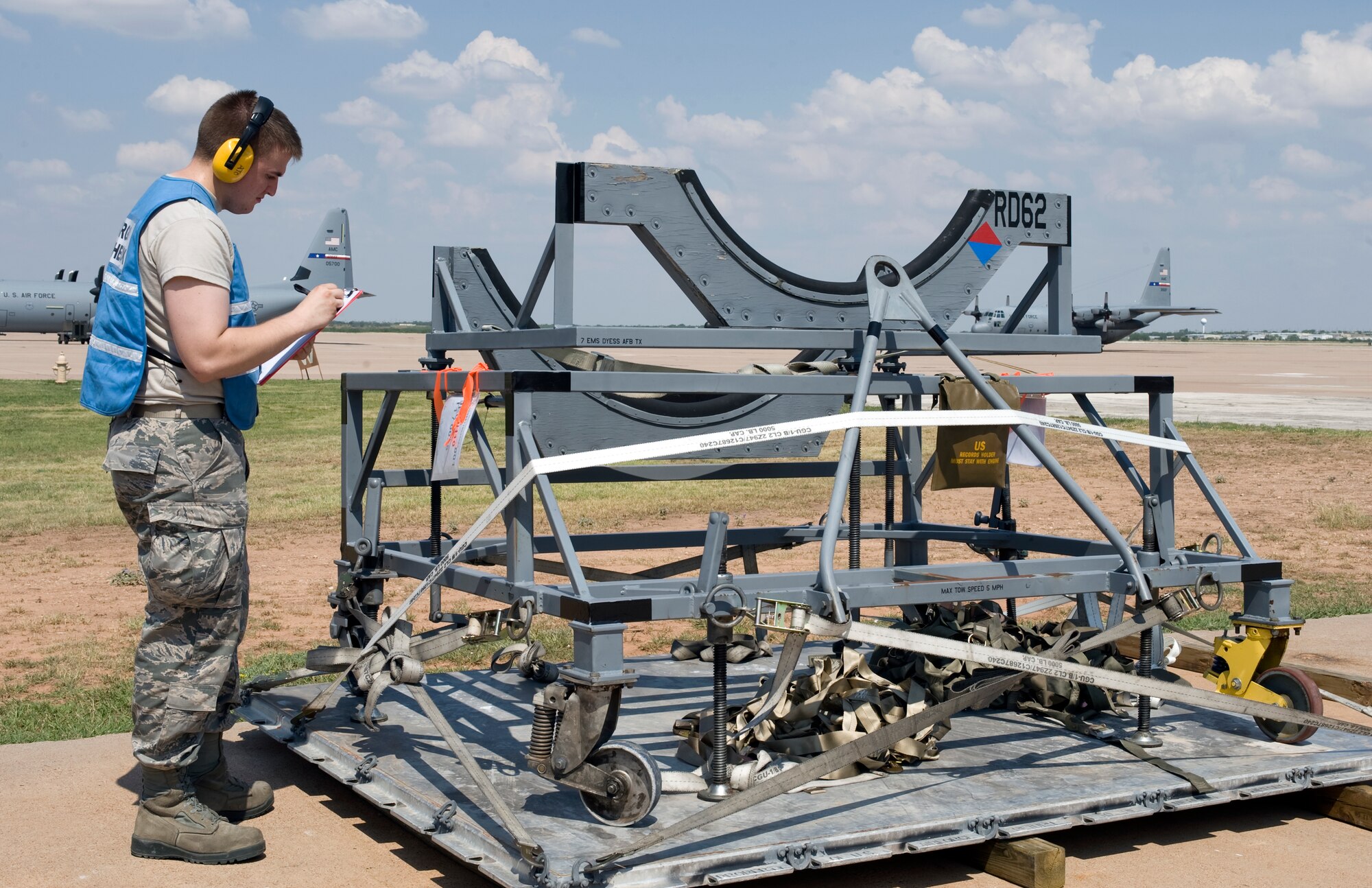 Airman 1st Class Zachary West, 7th Logistics Readiness Squadron, checks over a cargo pallet during an Operational Readiness Exercise July 12, 2012, at Dyess Air Force Base, Texas. Processing cargo quickly and accurately is a vital part of getting the equipment where it needs to be.  Airmen from the 7th LRS must ensure the cargo is weighed properly, secure and safe before it is loaded on the aircraft. (U.S. Air Force photo by Staff Sgt. Richard P. Ebensberger/ Released)