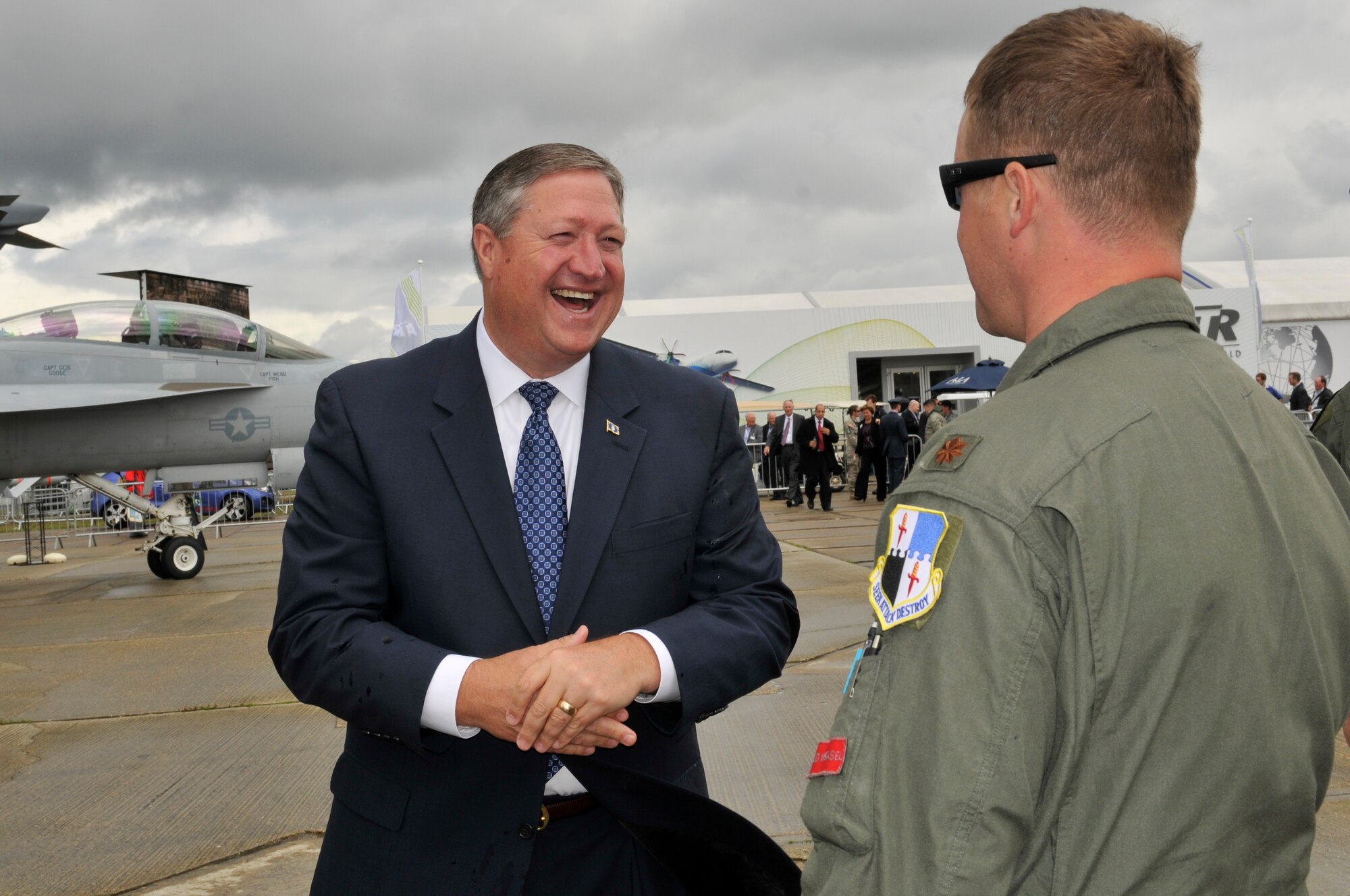 FARNBOROUGH, England - Secretary of the Air Force Michael Donley shares a laugh with Maj. Phil Johnston, 480th Fighter Squadron pilot, July 10, 2012, during a visit to the Farnborough International Air Show in Farnborough, England. Approximately 90 aircrew and support personnel from bases in Europe and the United States are participating in the air show. Participation in this premier event demonstrates that U.S. defense industry offers state-of-the-art capabilities vital for the support and protection of our Allies' and Partners' national-security interests. (U.S. Air Force photo by Tech. Sgt. Lee A. Osberry Jr.)