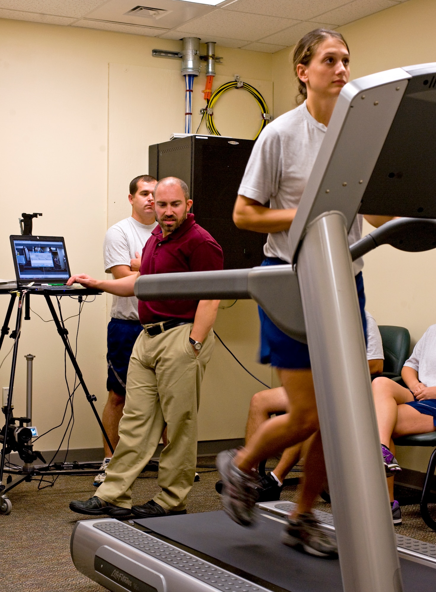 Brent Cowen, a Health and Wellness Center exercise physiologist, studies the running stride of 1st Lt. Kristen Baker, an assistant operations officer from 1st Special Operations Force Support Squadron, during a running clinic in the HAWC at Hurlburt Field, Fla., July 11, 2012. Exercise also improves Airman physical resiliency by reducing stress. (U.S. Air Force photo/Airman 1st Class Michelle Vickers) (RELEASED) 
